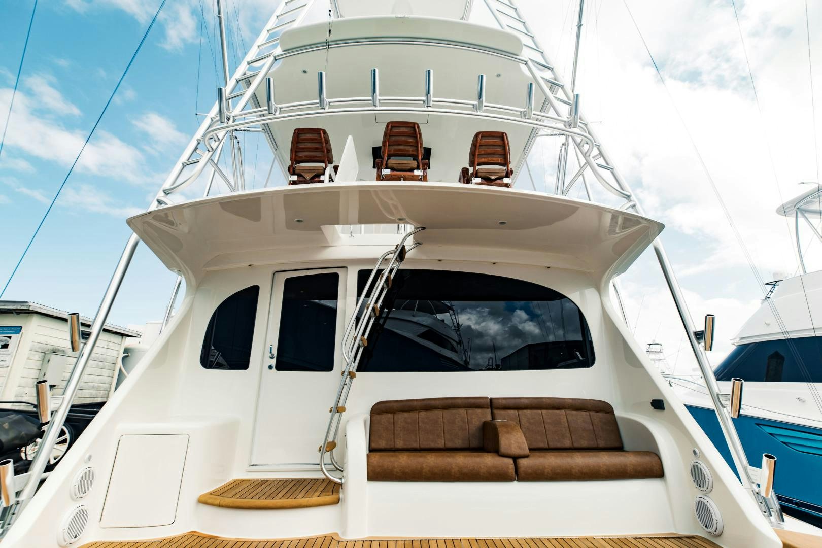 a white boat with a brown seat aboard SHOE Yacht for Sale