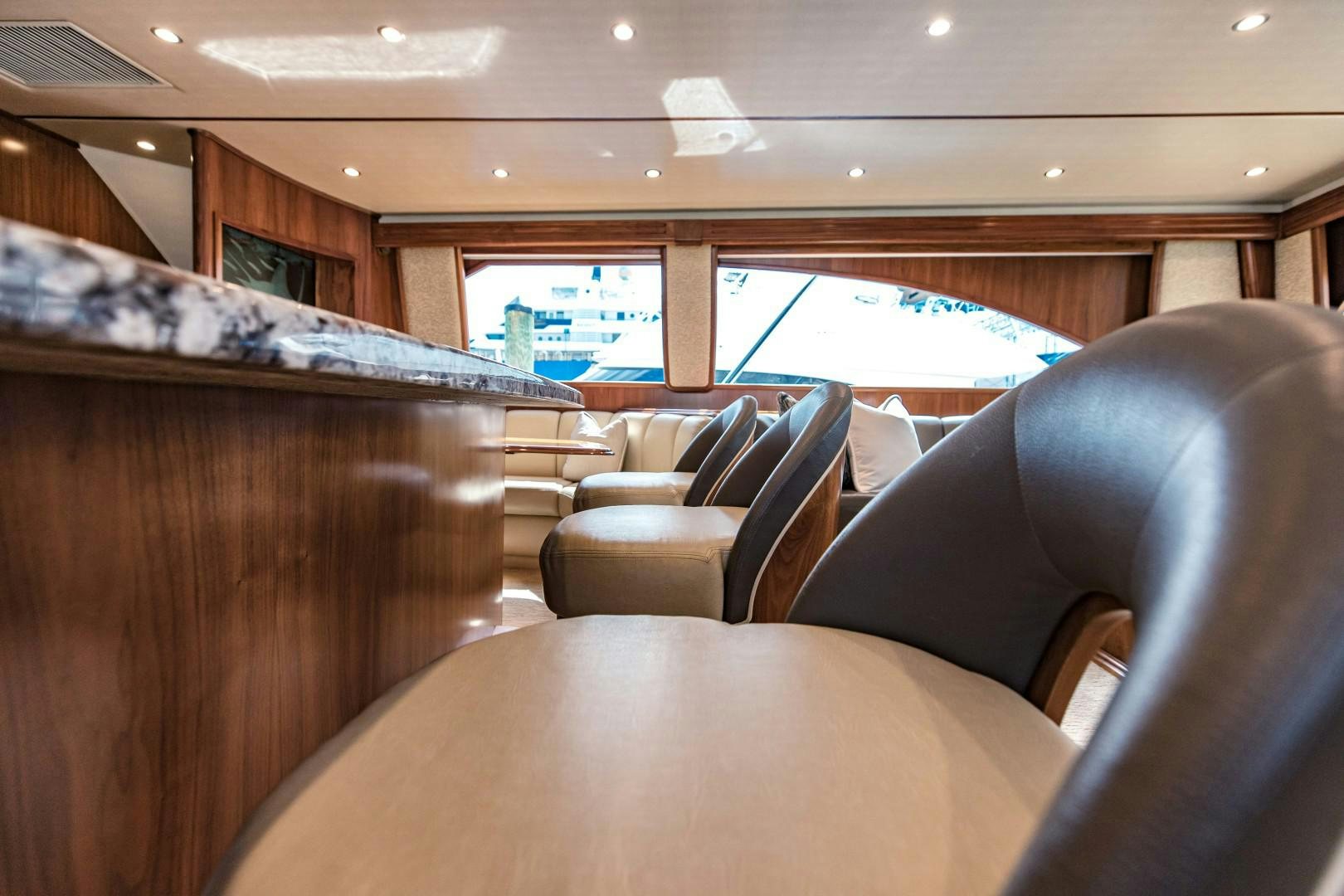 a room with leather couches aboard SHOE Yacht for Sale