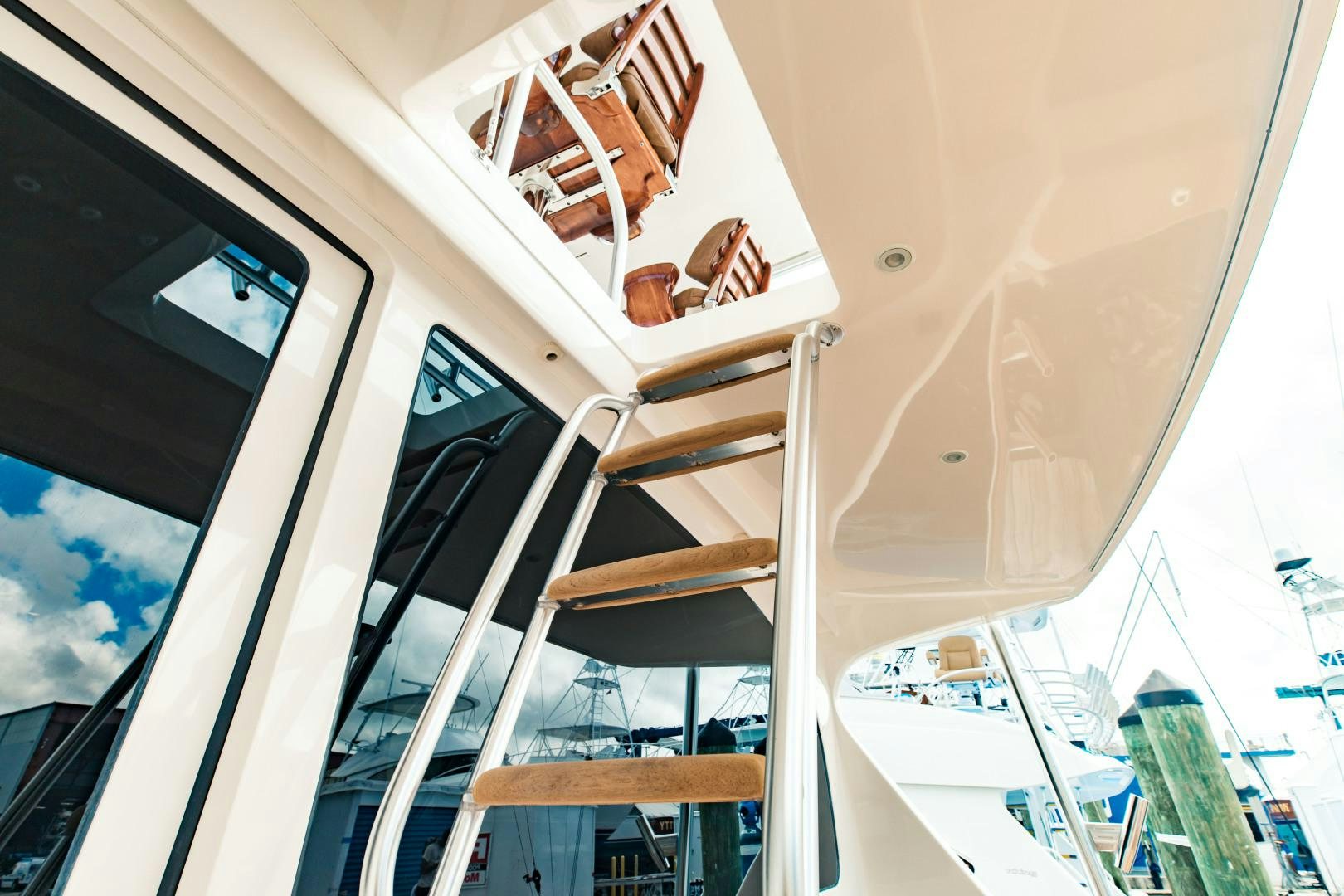 a white boat with a wooden dock aboard SHOE Yacht for Sale