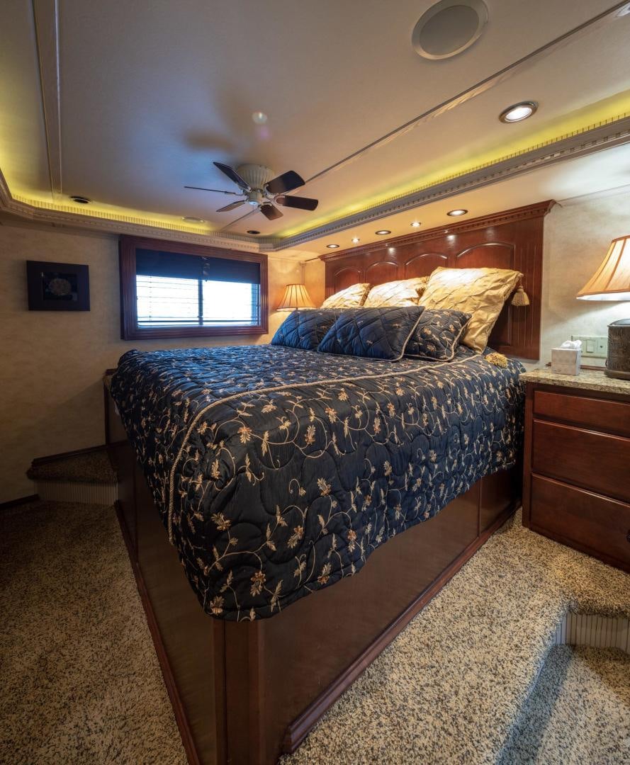 a bed with a blue comforter aboard KNOT TIDE DOWN Yacht for Sale