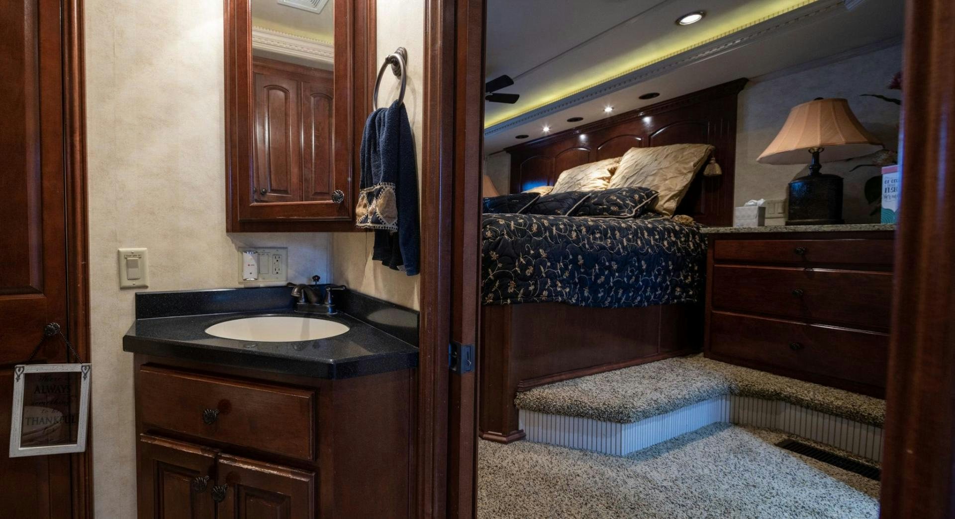 a bedroom with a bed and a sink aboard KNOT TIDE DOWN Yacht for Sale