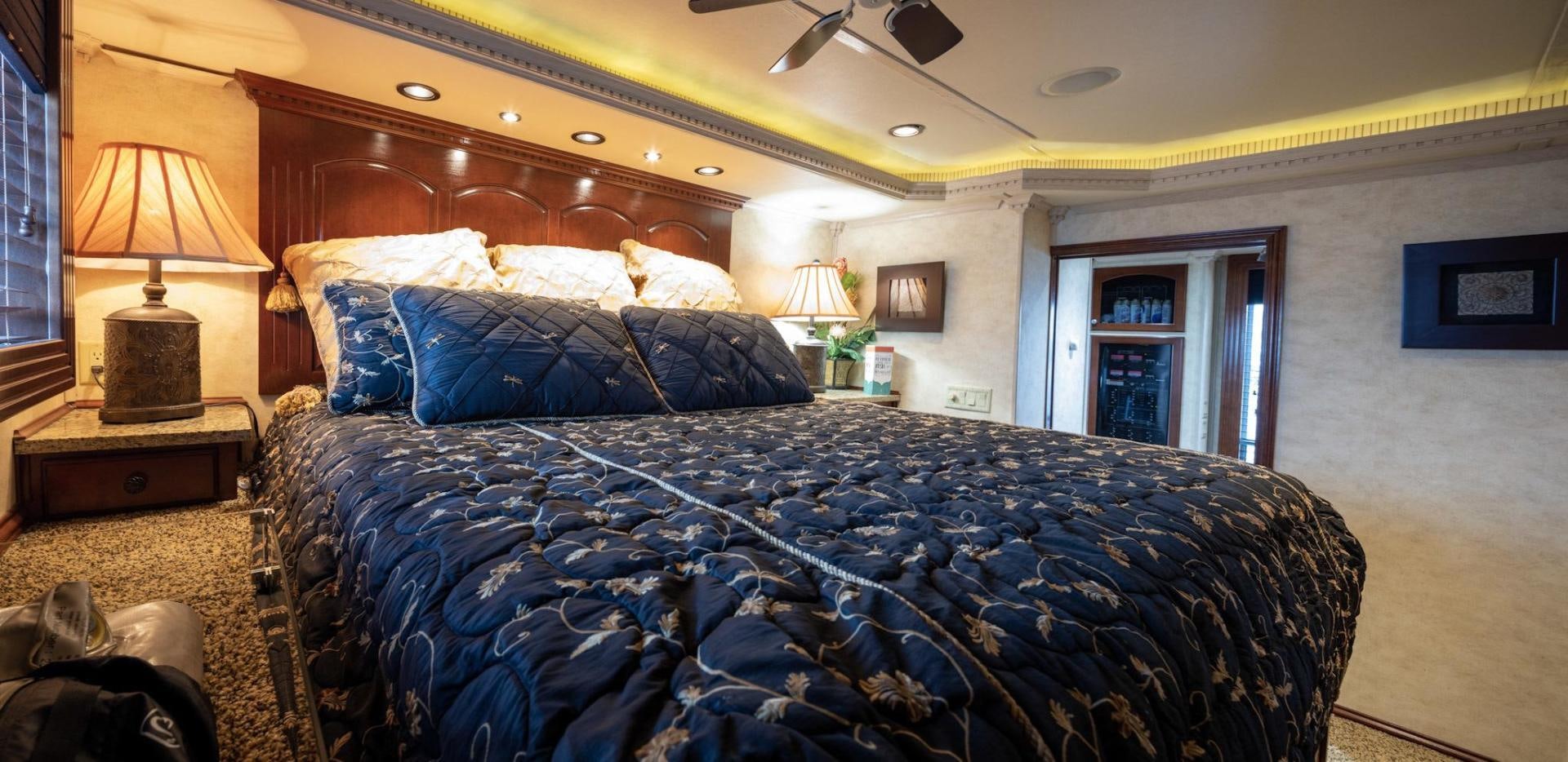 a bed with blue sheets aboard KNOT TIDE DOWN Yacht for Sale