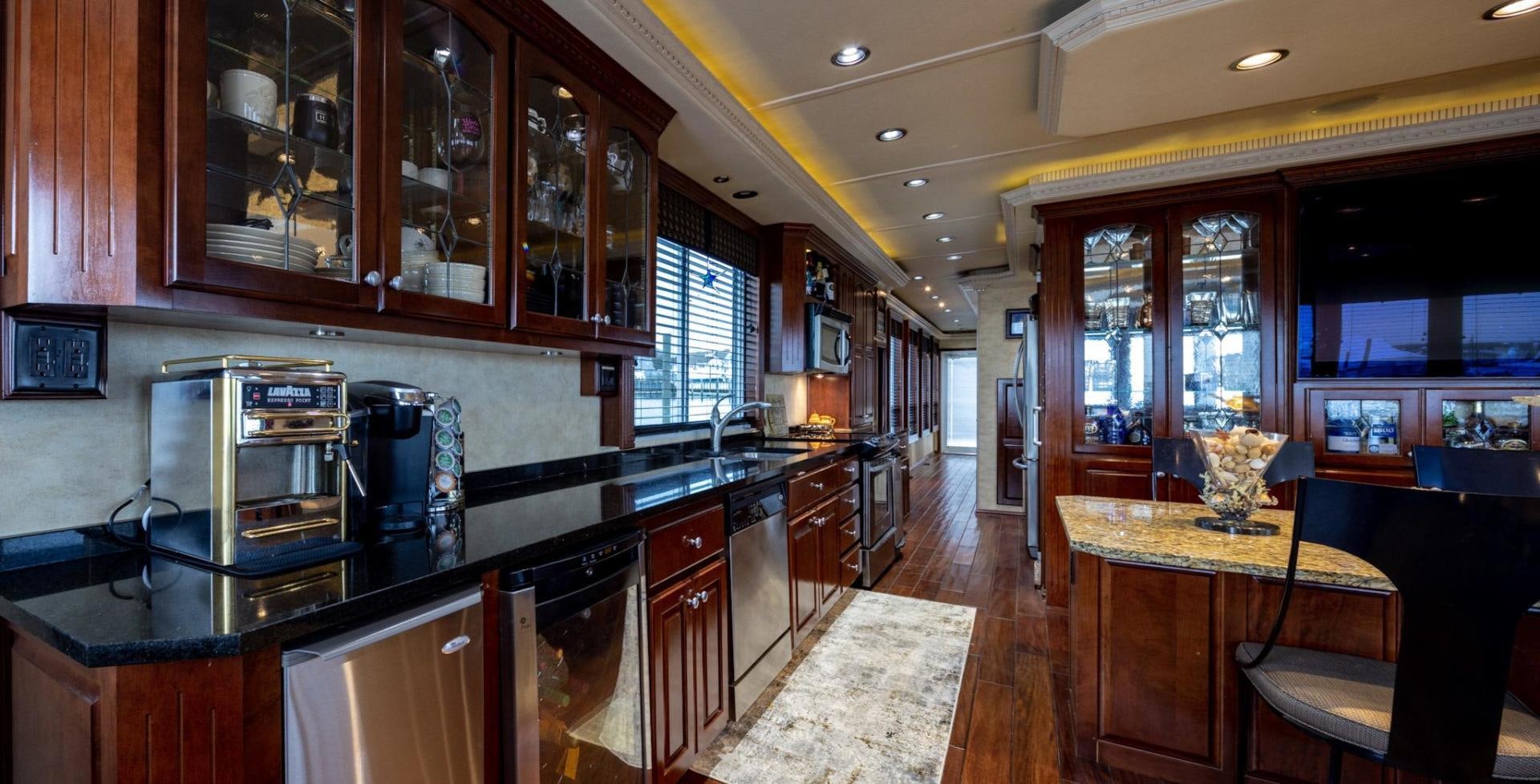 a kitchen with wooden cabinets aboard KNOT TIDE DOWN Yacht for Sale