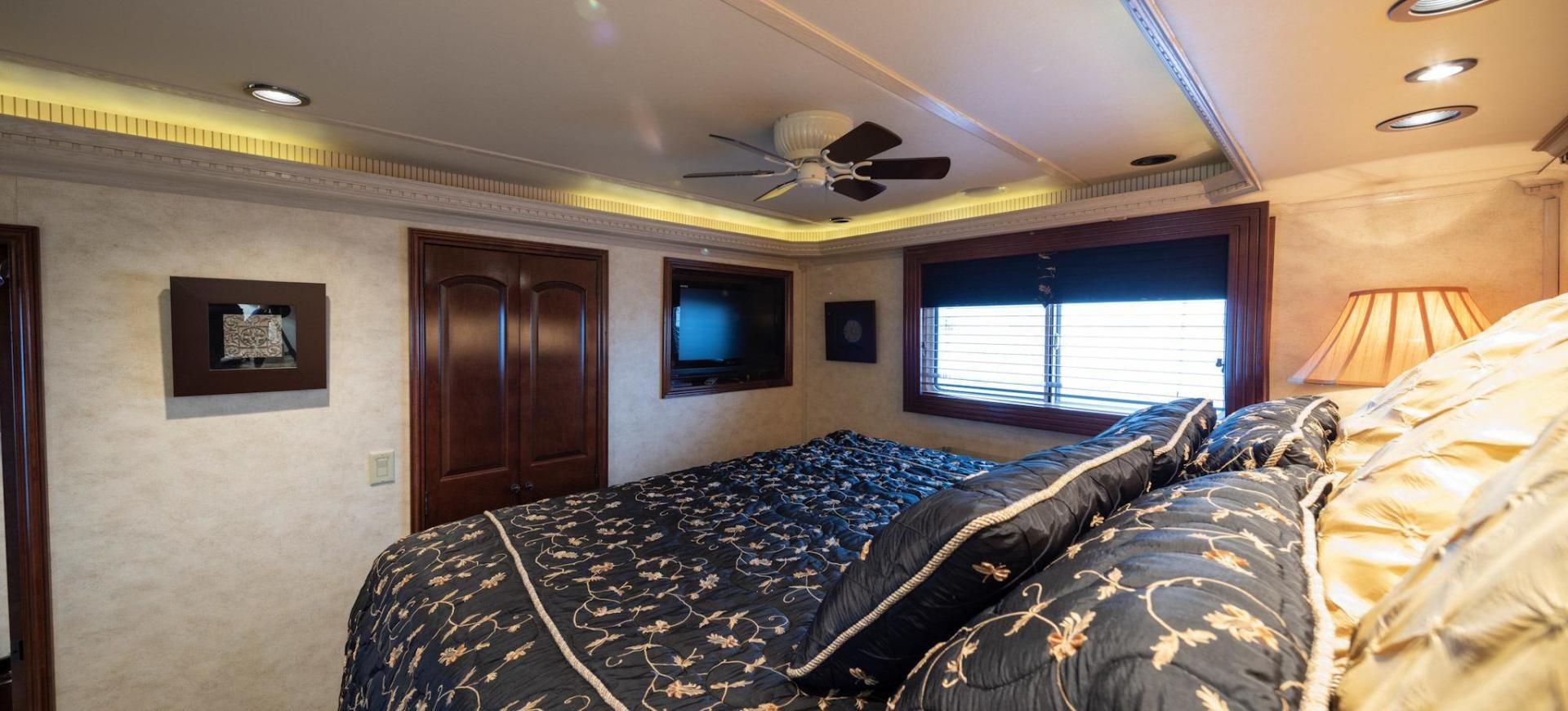 a bedroom with a bed and a ceiling fan aboard KNOT TIDE DOWN Yacht for Sale