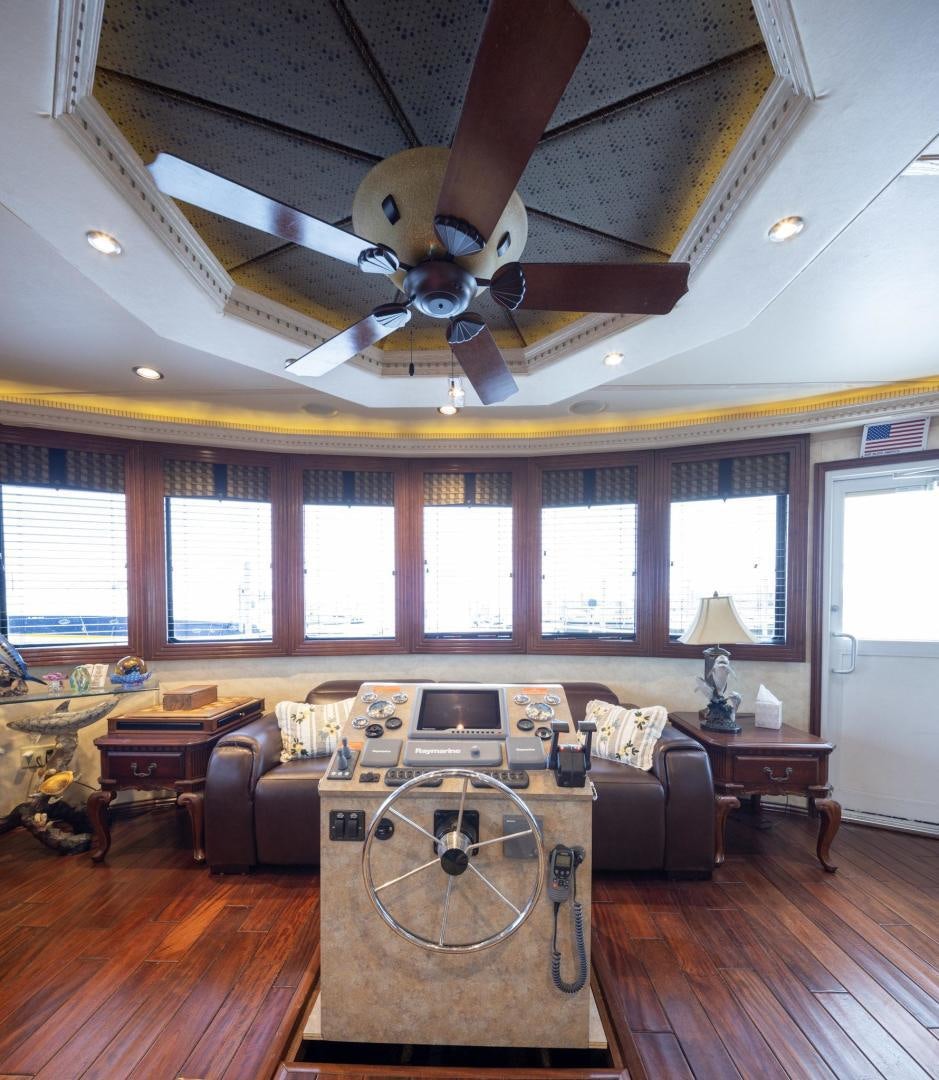 a living room with a ceiling fan aboard KNOT TIDE DOWN Yacht for Sale