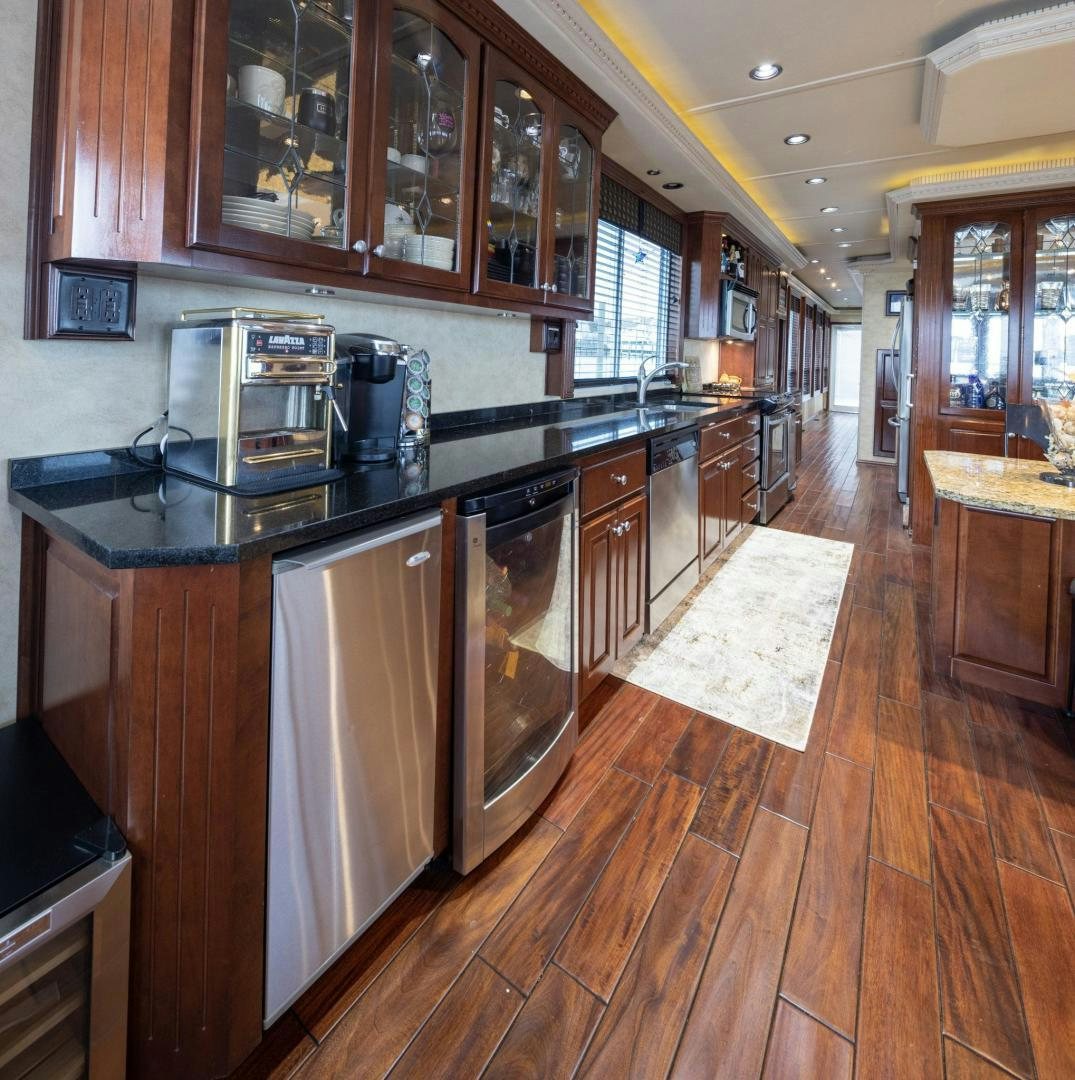 a kitchen with wooden cabinets aboard KNOT TIDE DOWN Yacht for Sale
