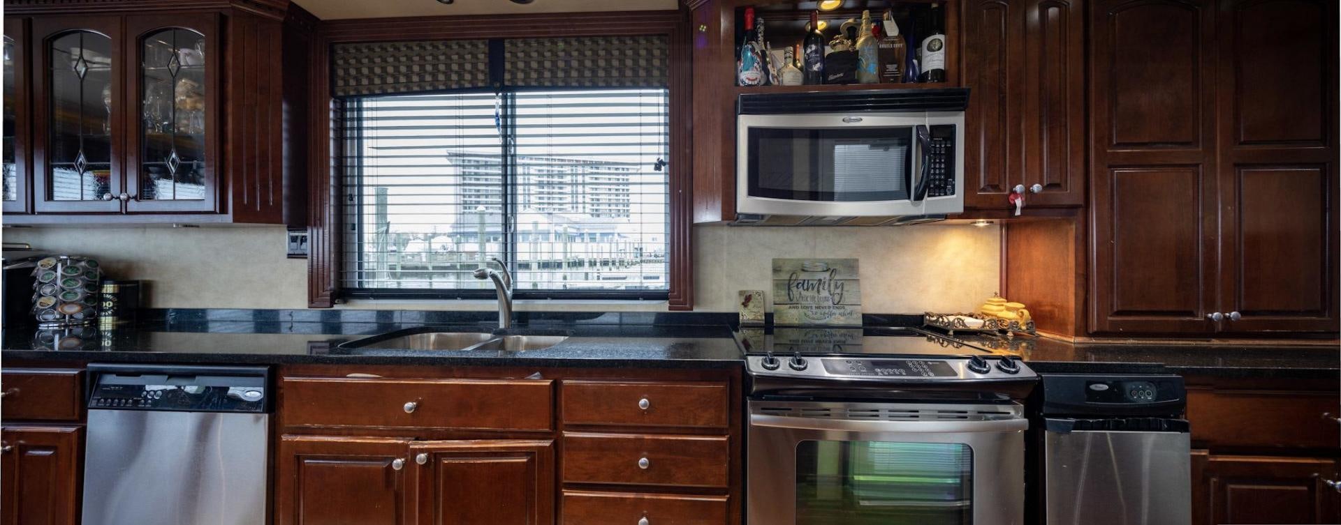 a kitchen with wooden cabinets aboard KNOT TIDE DOWN Yacht for Sale