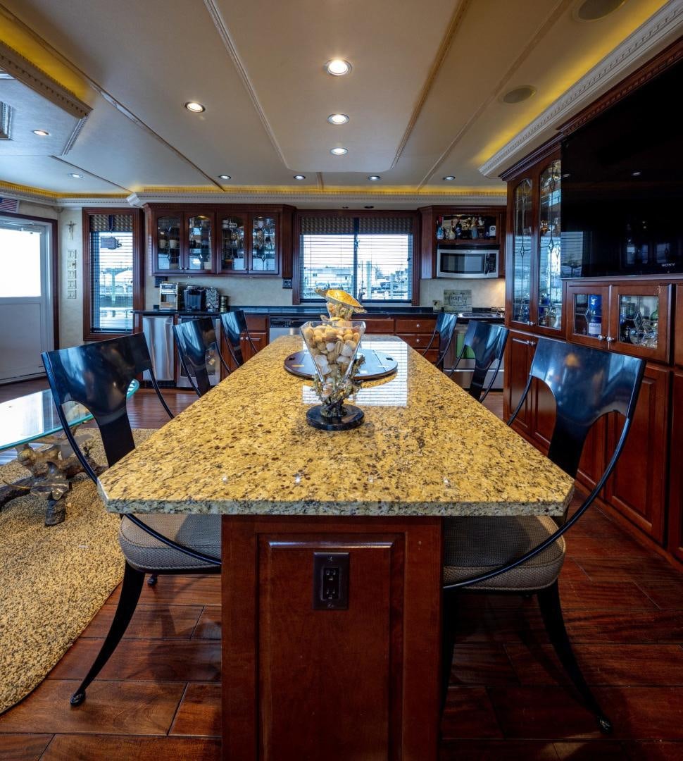 a large table with a glass vase on top aboard KNOT TIDE DOWN Yacht for Sale