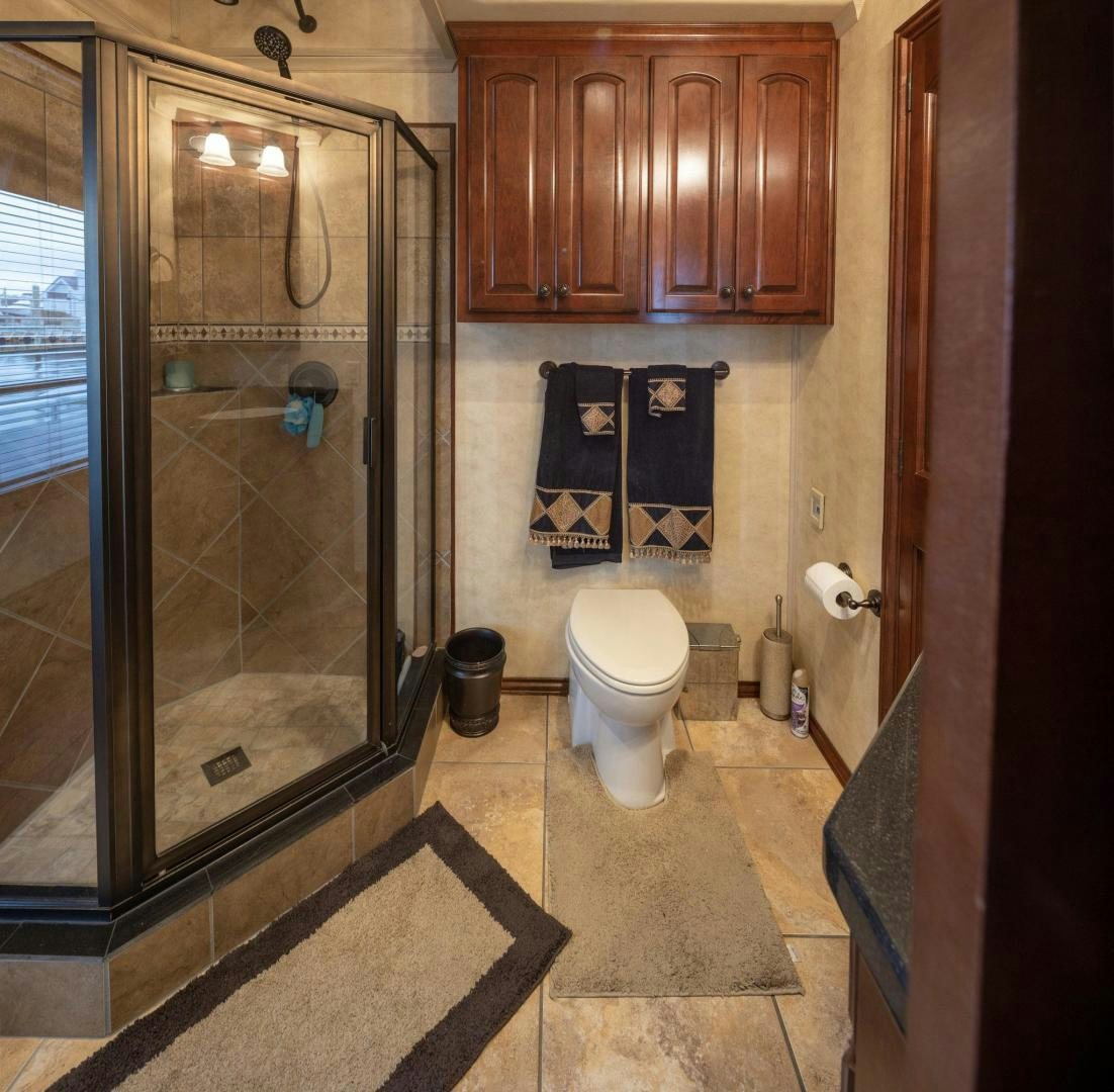 a bathroom with a glass shower aboard KNOT TIDE DOWN Yacht for Sale