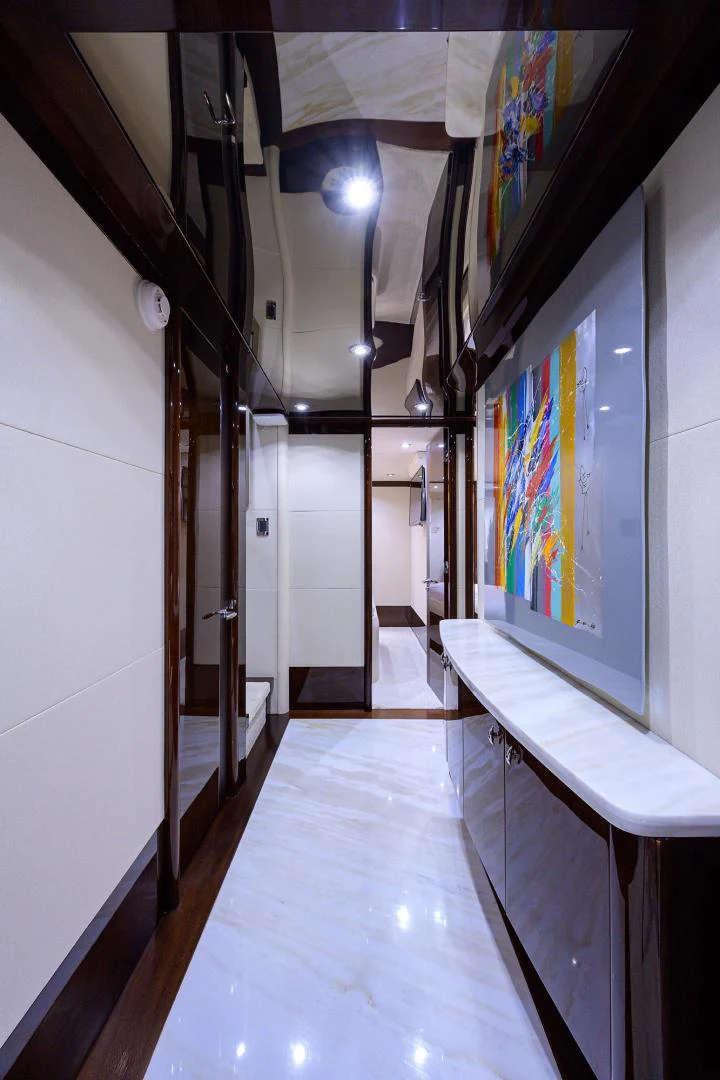 a hallway with art on the walls aboard PURE ROMANCE Yacht for Sale