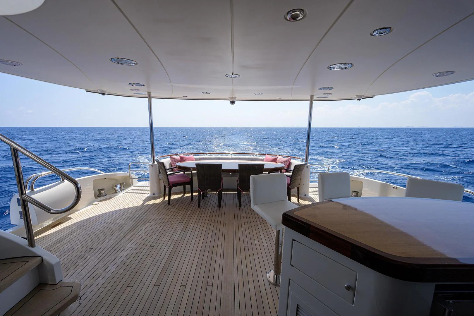 a boat with a table and chairs on the deck aboard PURE ROMANCE Yacht for Sale