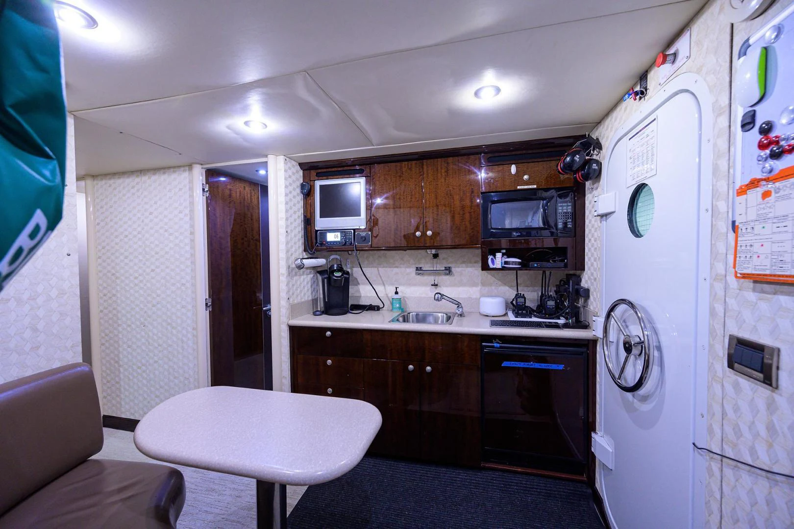 a small kitchen with a fridge aboard PURE ROMANCE Yacht for Sale