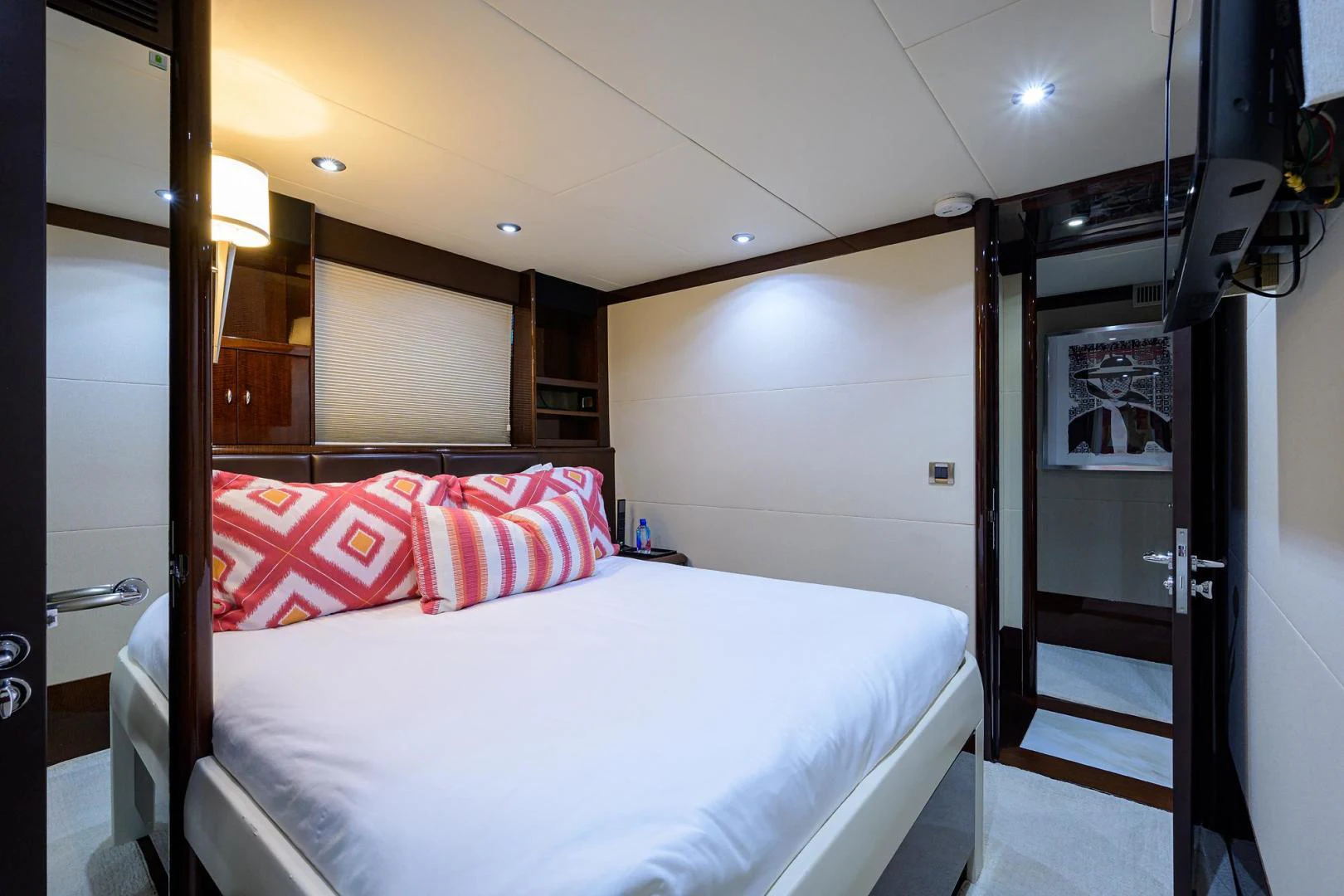 a room with a bed and a mirror aboard PURE ROMANCE Yacht for Sale