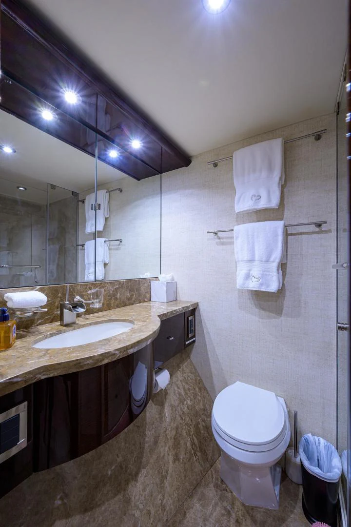 a bathroom with a sink toilet and a mirror aboard PURE ROMANCE Yacht for Sale