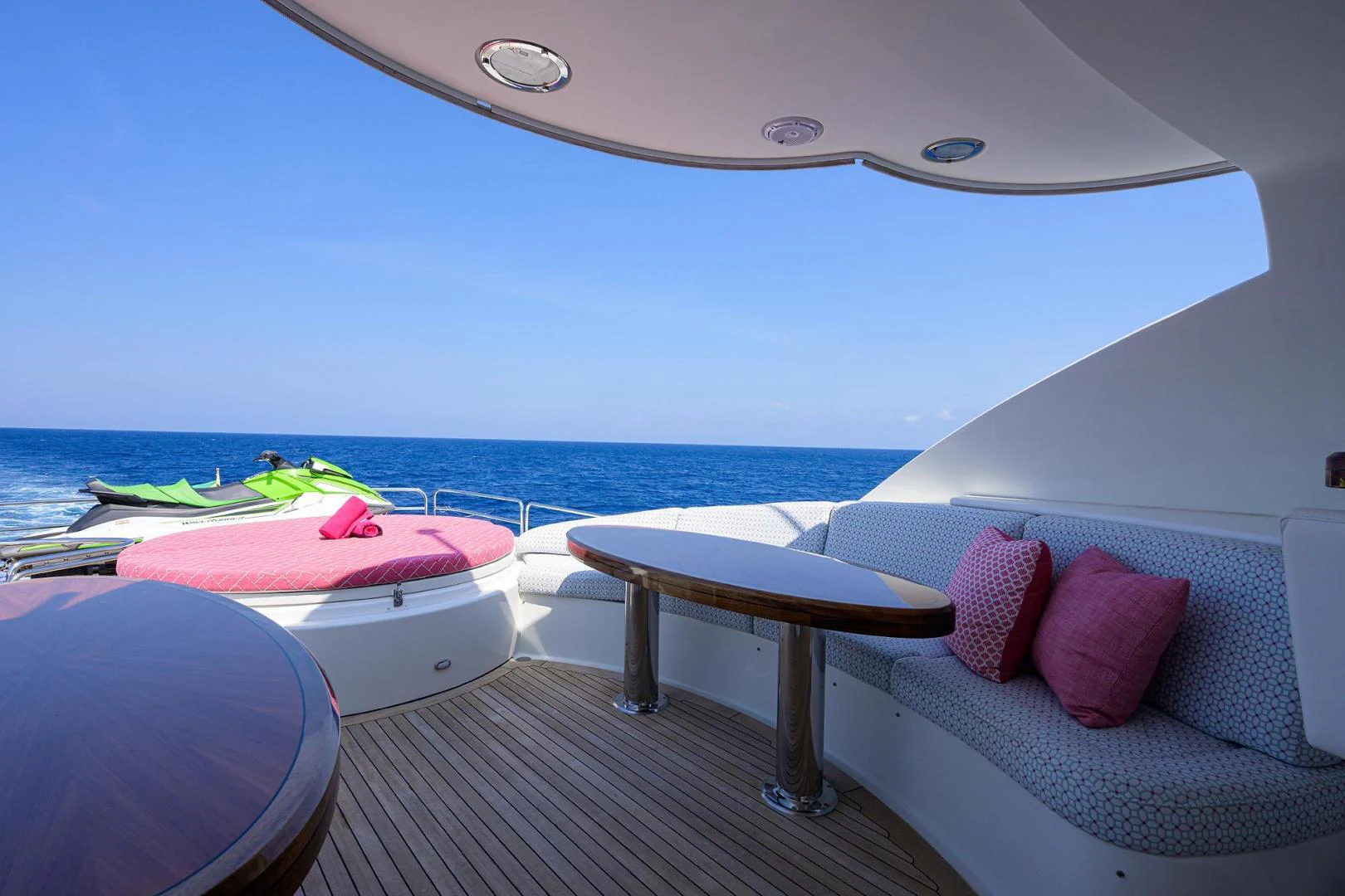 a lounge area with a table and chairs on it aboard PURE ROMANCE Yacht for Sale