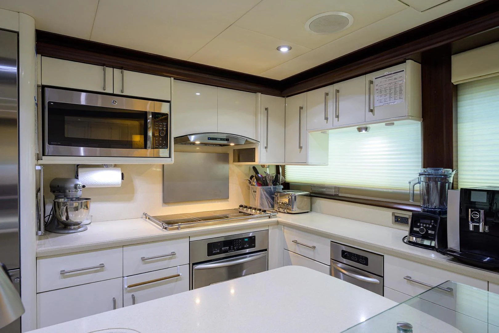 a kitchen with white cabinets aboard PURE ROMANCE Yacht for Sale