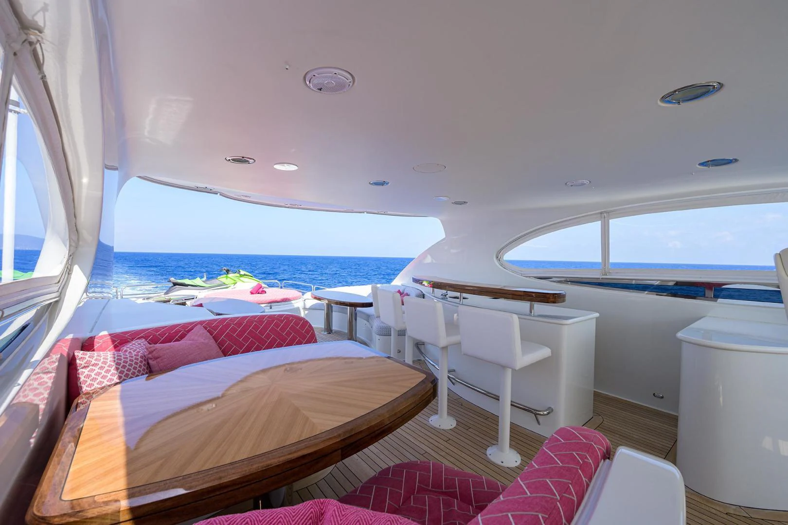 a room with a bed and a table and chairs aboard PURE ROMANCE Yacht for Sale