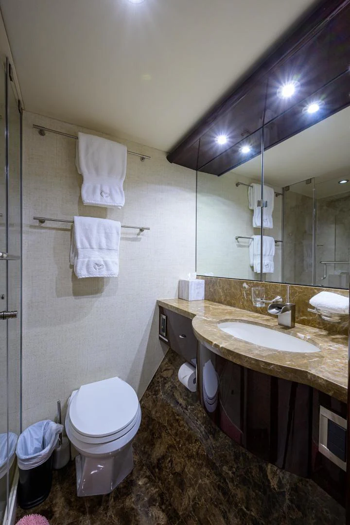 a bathroom with a toilet and a sink aboard PURE ROMANCE Yacht for Sale