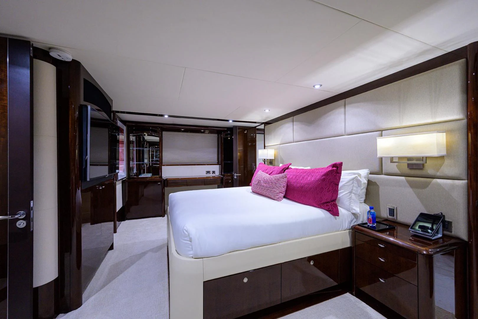 a bedroom with a bed and a desk aboard PURE ROMANCE Yacht for Sale