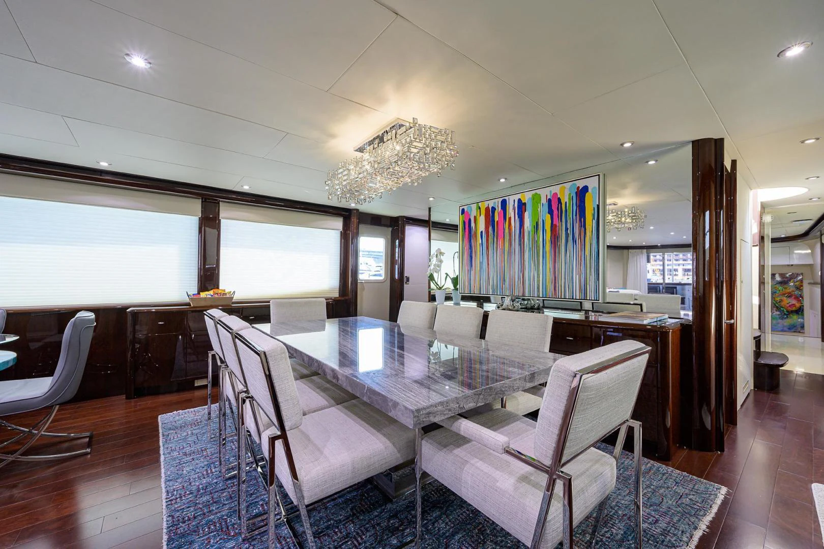 a room with a table chairs and a window aboard PURE ROMANCE Yacht for Sale