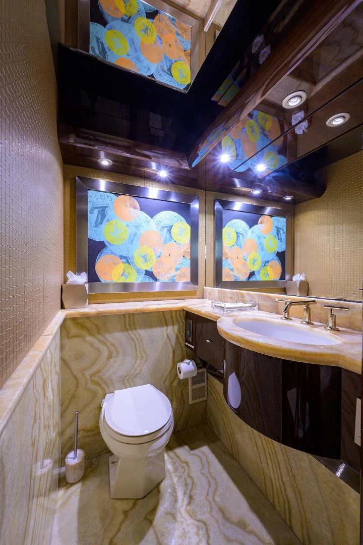 a bathroom with a toilet sink and a mirror aboard PURE ROMANCE Yacht for Sale
