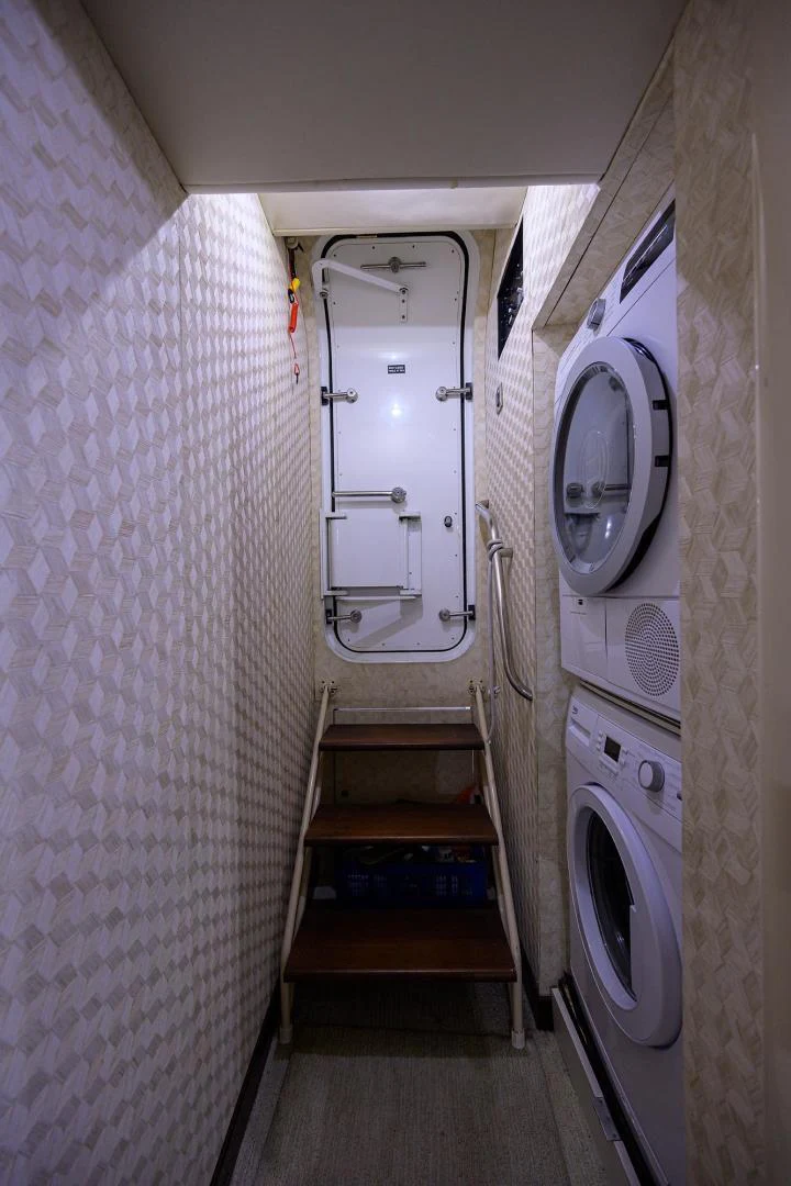 a small hallway with a washing machine aboard PURE ROMANCE Yacht for Sale