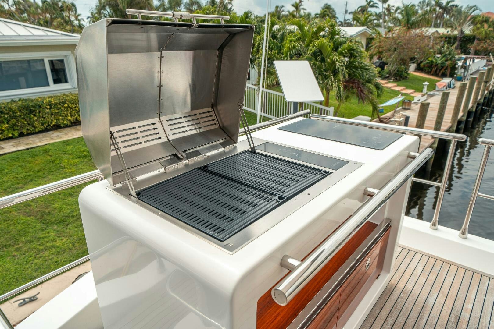 a deck with a grill and a deck and trees aboard VELOCITY Yacht for Sale