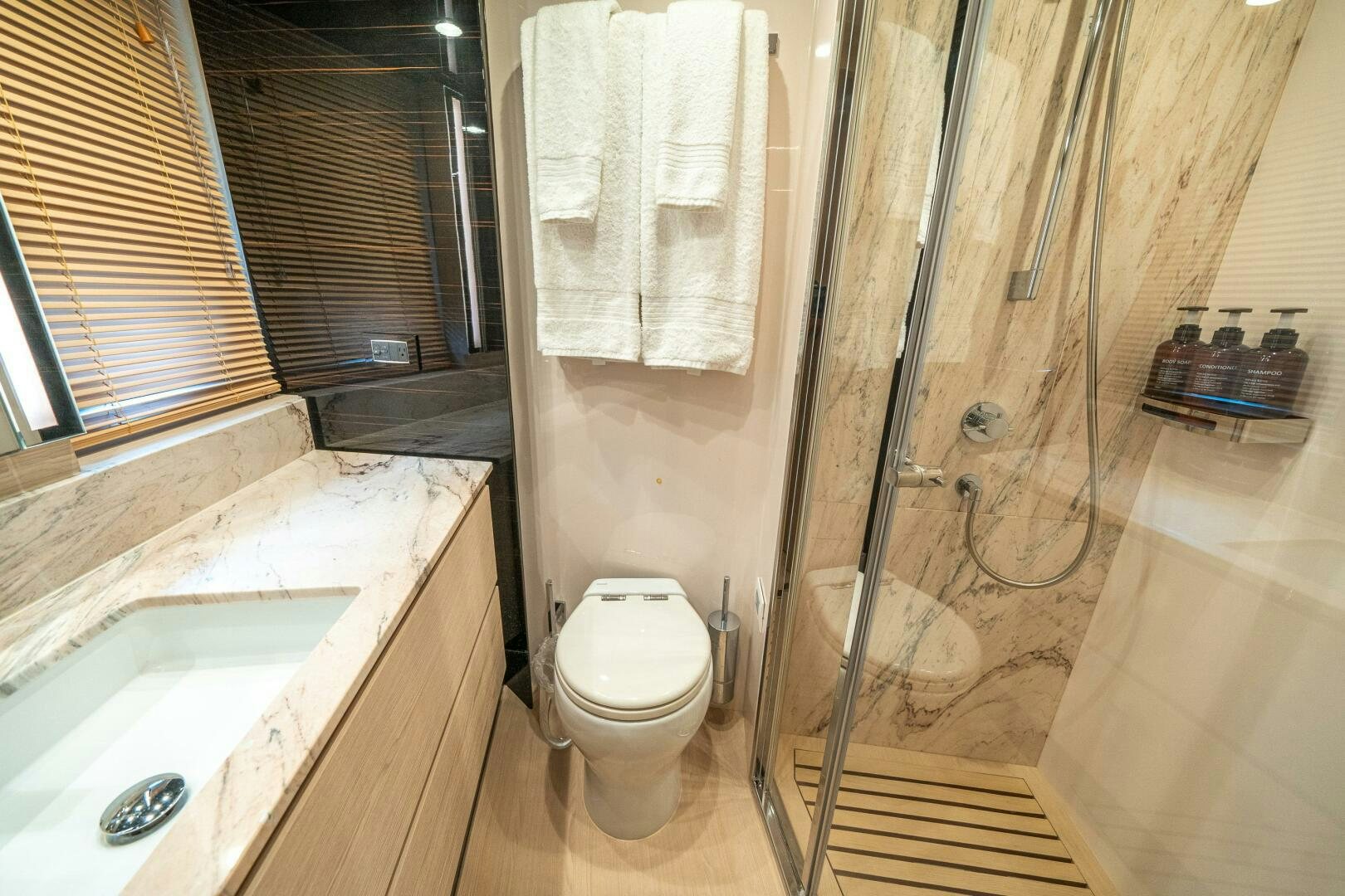 a bathroom with a toilet and sink aboard VELOCITY Yacht for Sale