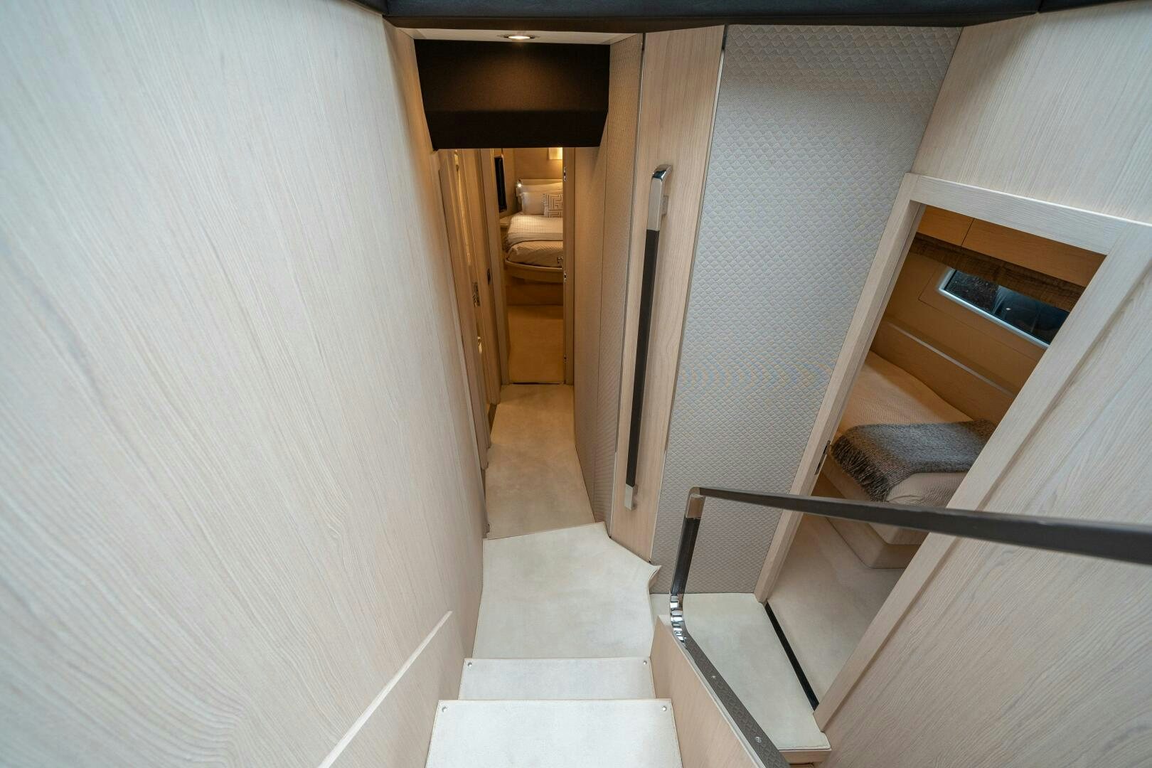 a room with a bed and a staircase aboard VELOCITY Yacht for Sale