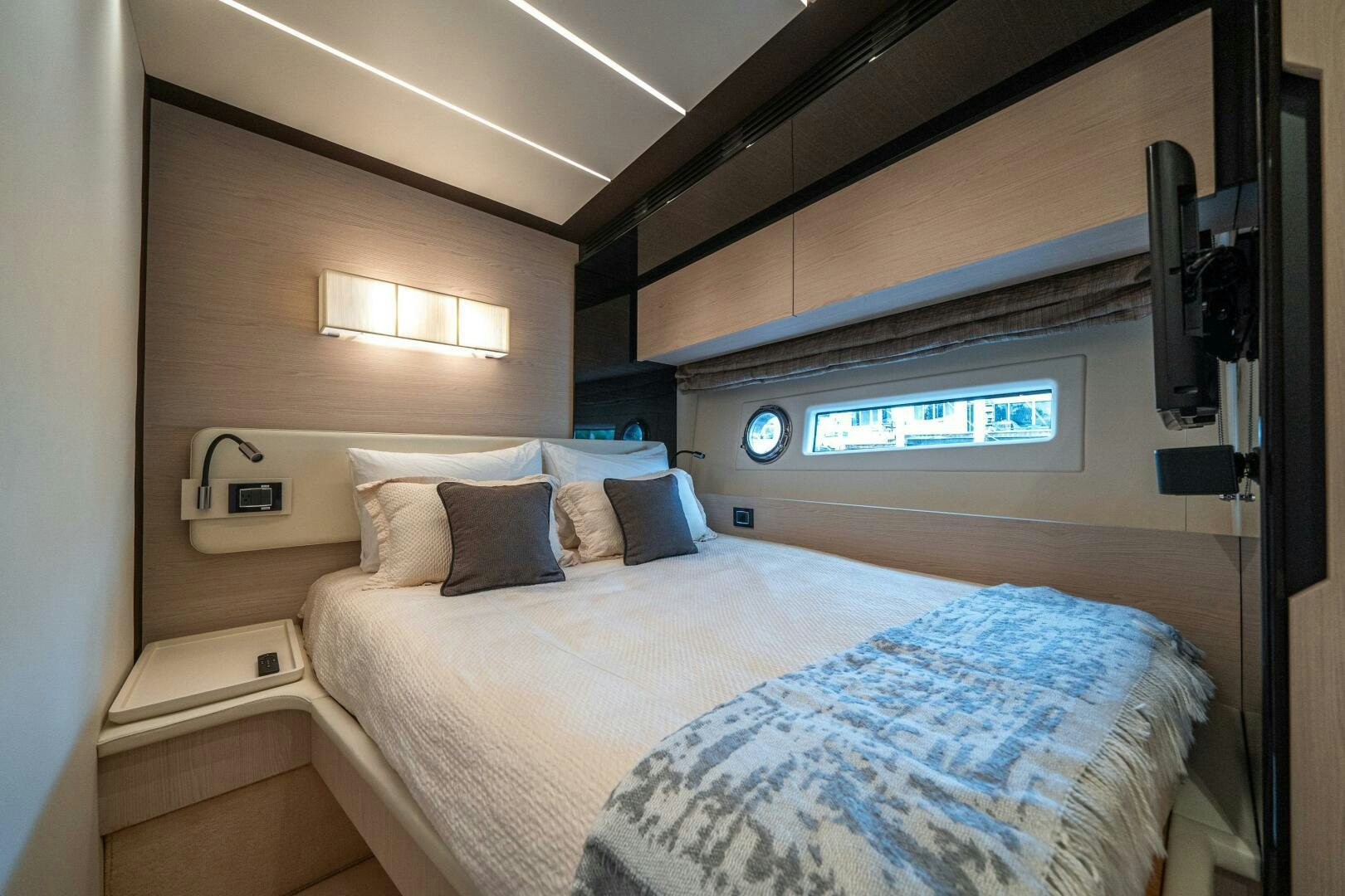 a bed with a blue and white bed spread aboard VELOCITY Yacht for Sale
