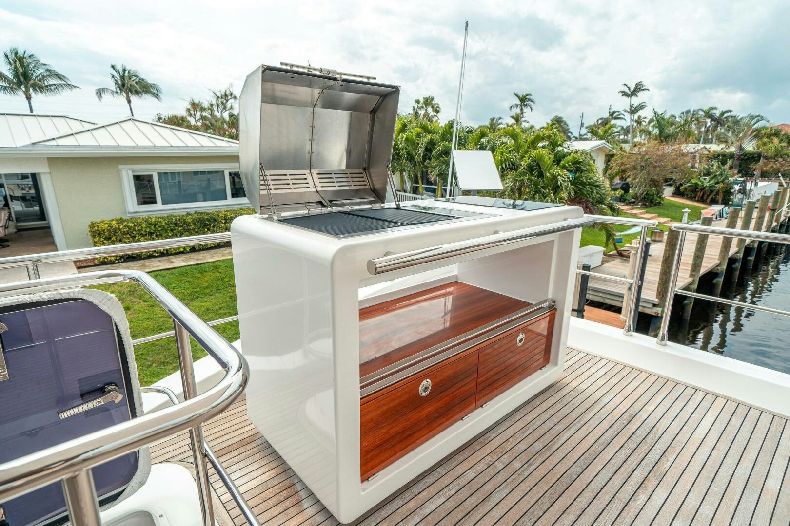 a deck with a television and a deck with trees and a building aboard VELOCITY Yacht for Sale