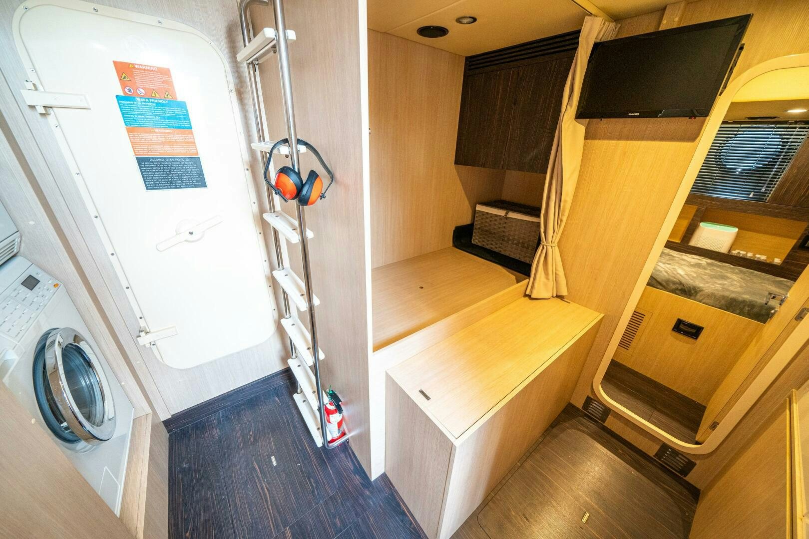 a room with a television and a table aboard VELOCITY Yacht for Sale