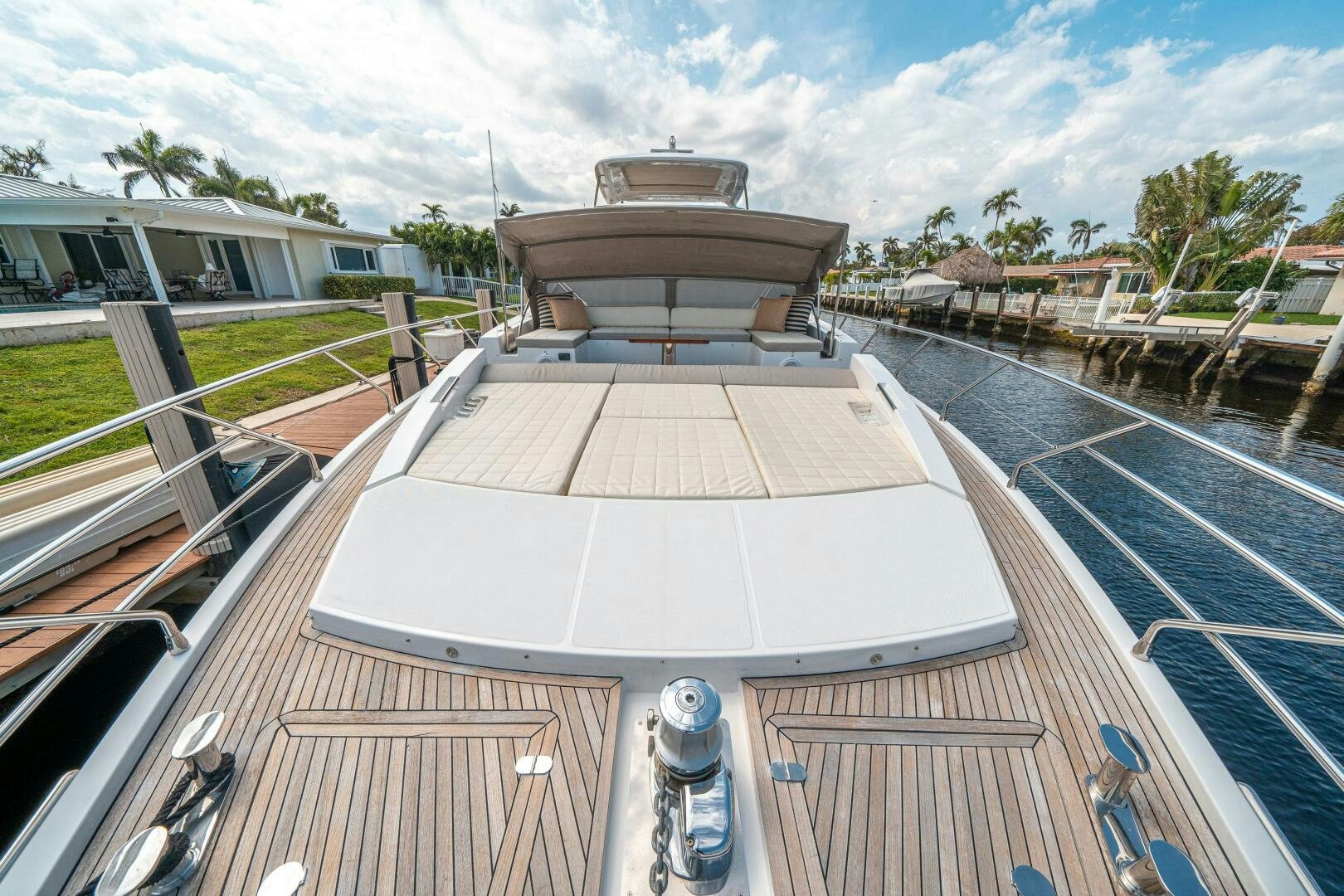 a deck with a deck and a building with trees and grass aboard VELOCITY Yacht for Sale