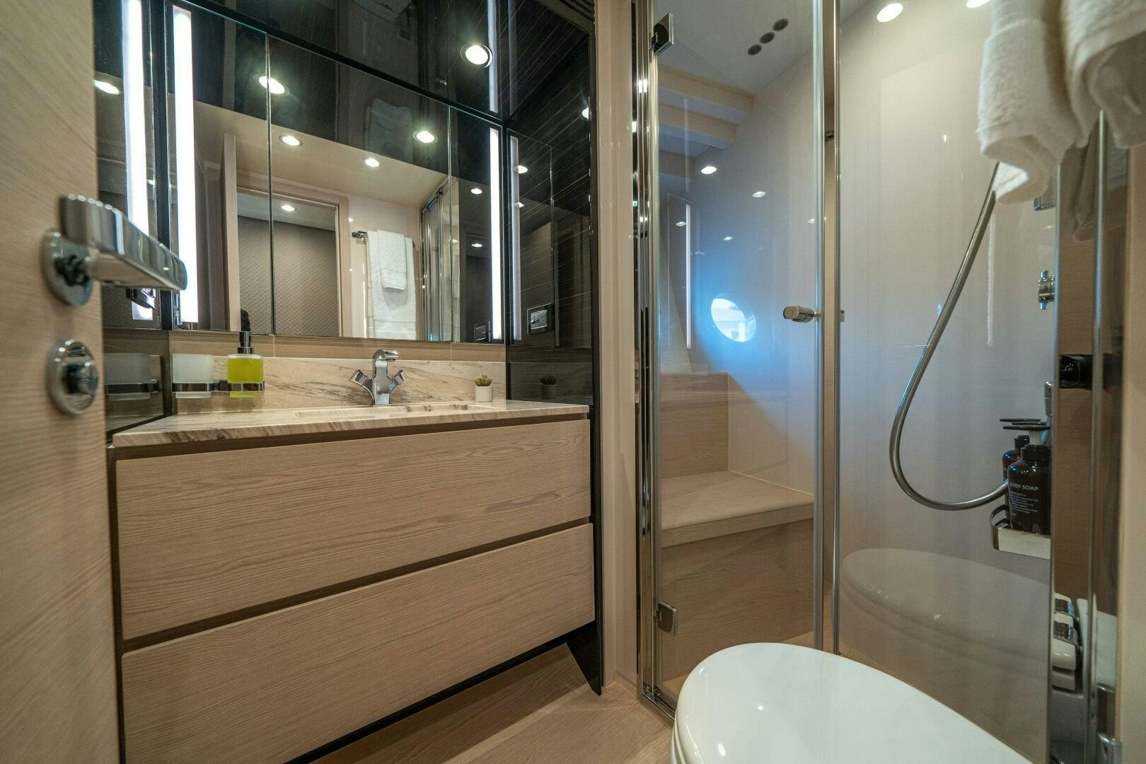 a bathroom with a glass shower aboard VELOCITY Yacht for Sale