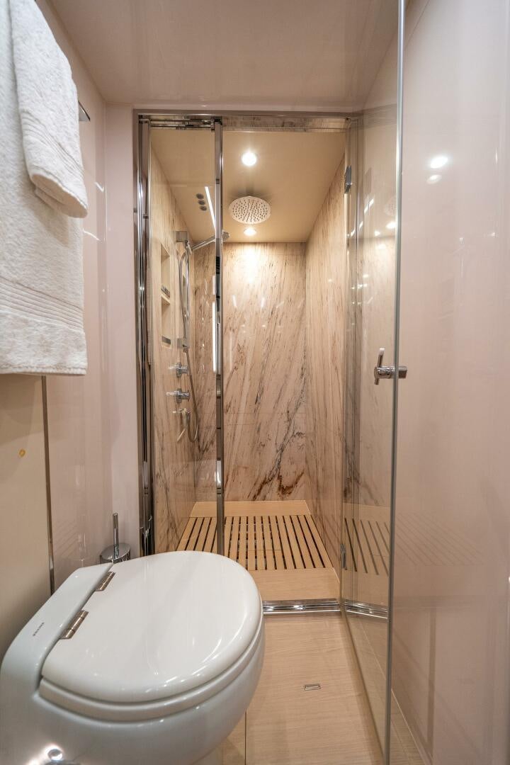a bathroom with a glass shower aboard VELOCITY Yacht for Sale