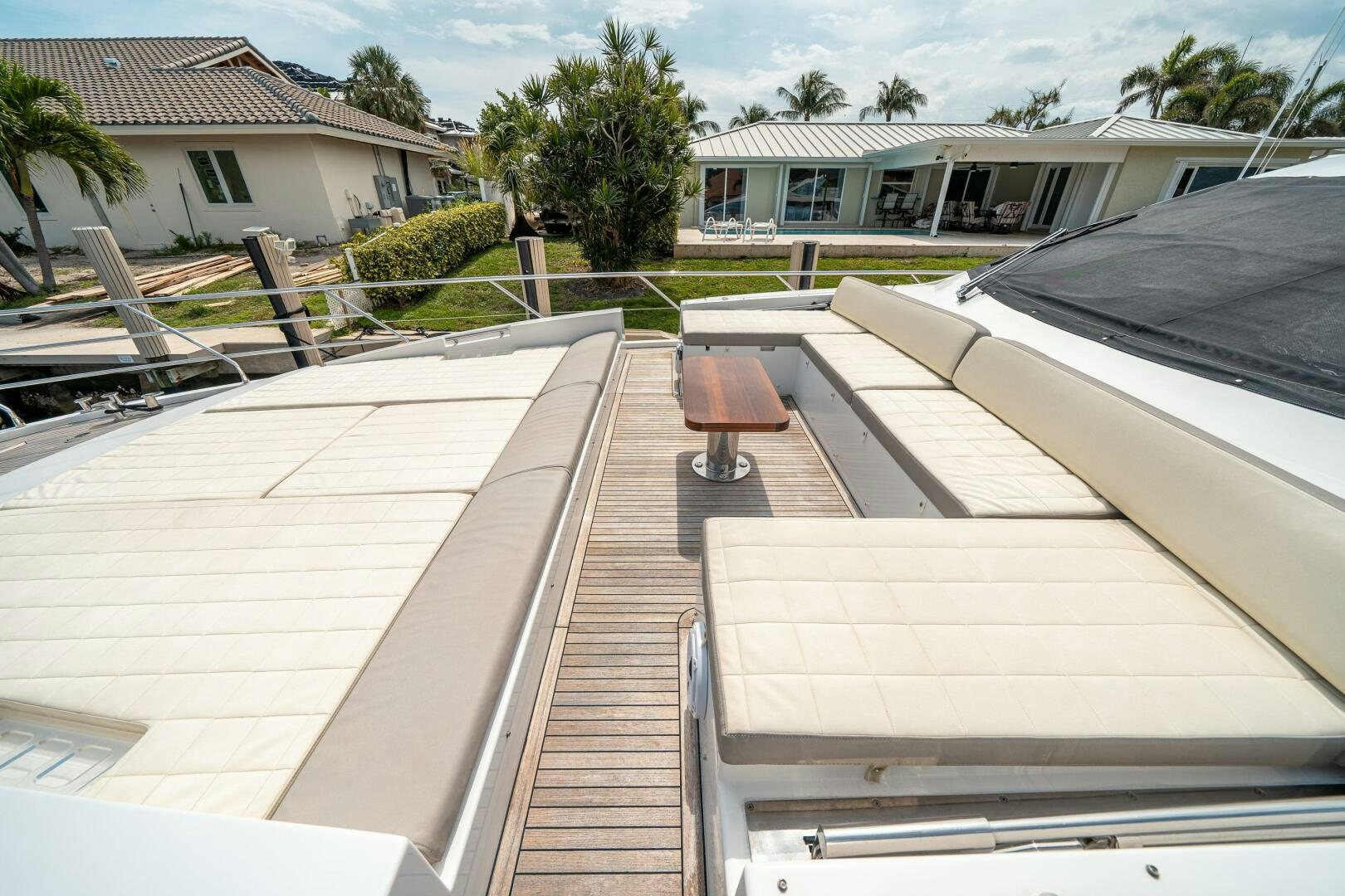 a deck with a bench and a deck with a house in the background aboard VELOCITY Yacht for Sale