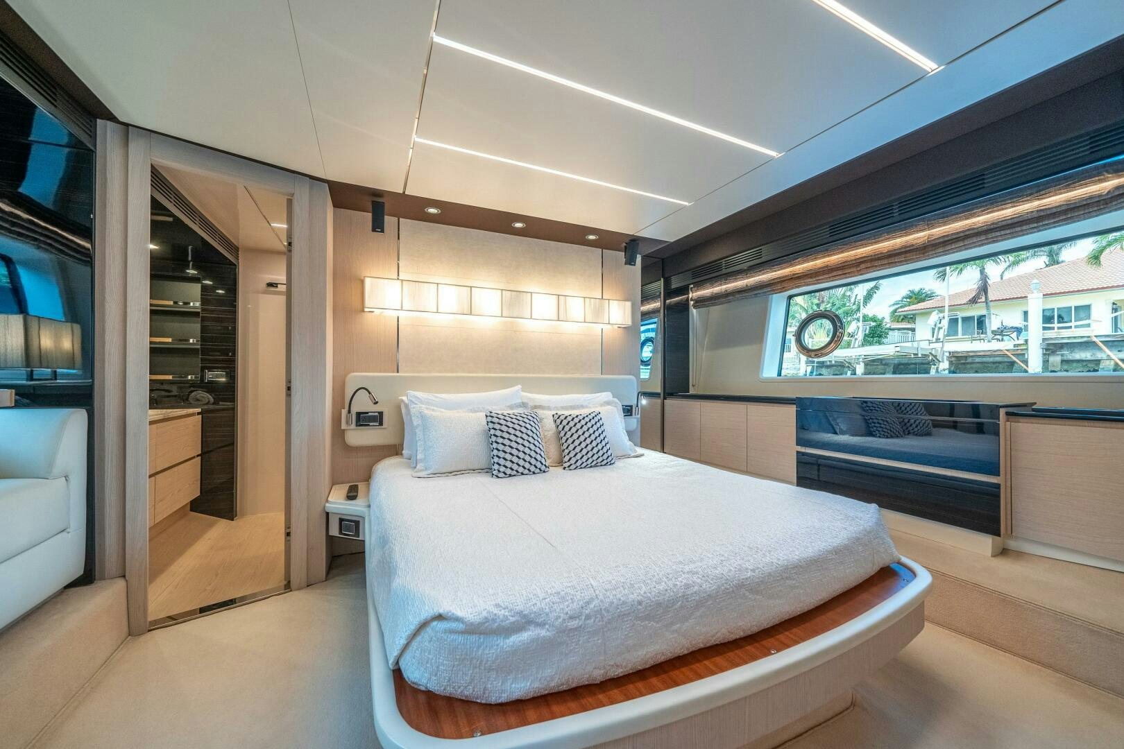 a room with a bed and a window aboard VELOCITY Yacht for Sale