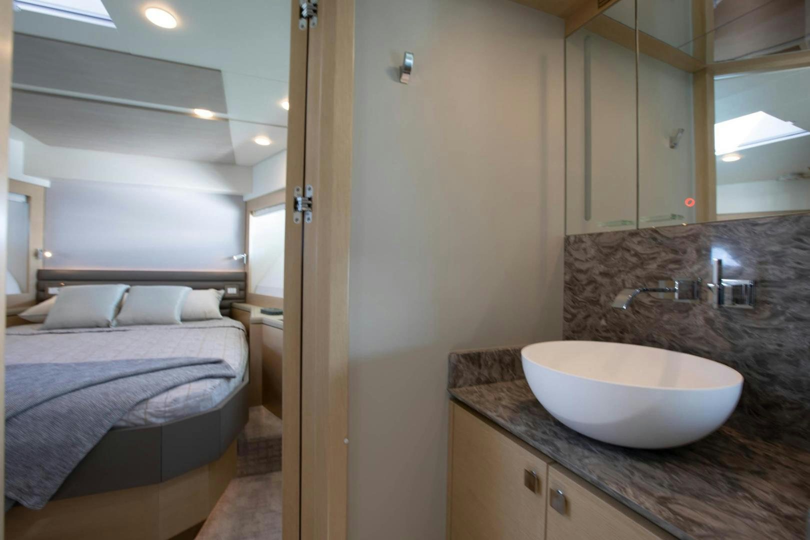 a bathroom with a sink and a bed aboard ABSOLUTELY Yacht for Sale