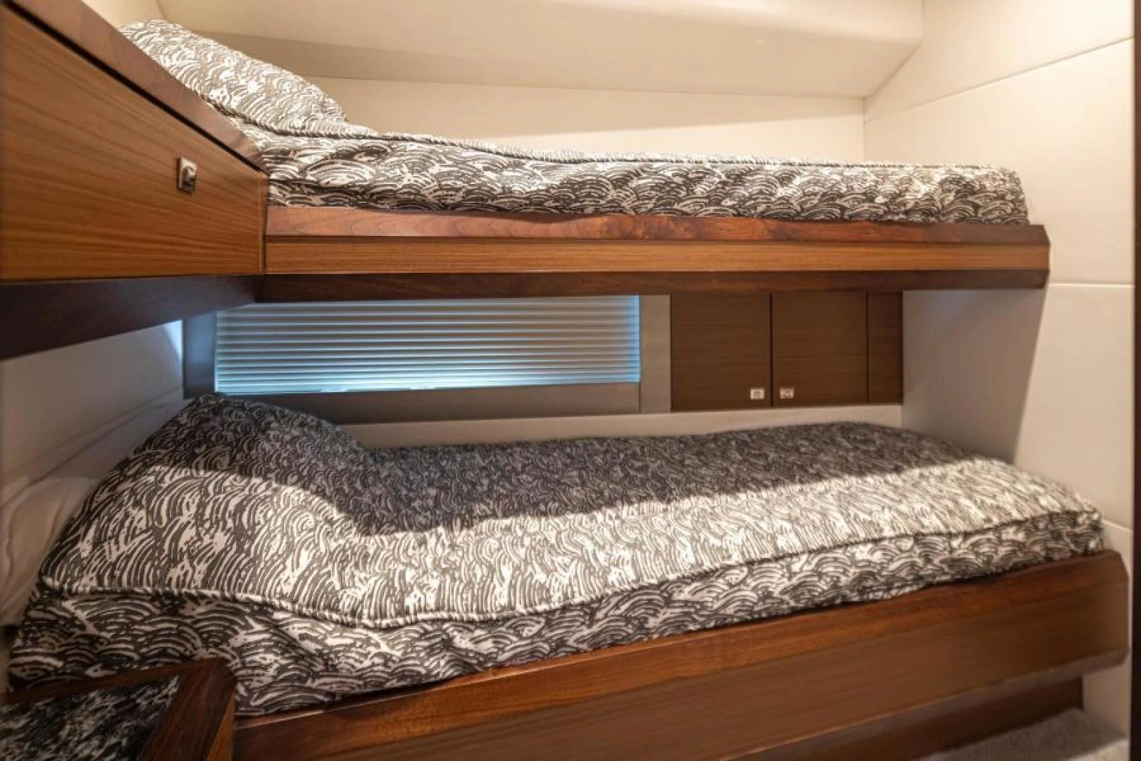 a bed with a wooden headboard aboard LIV MAS Yacht for Sale