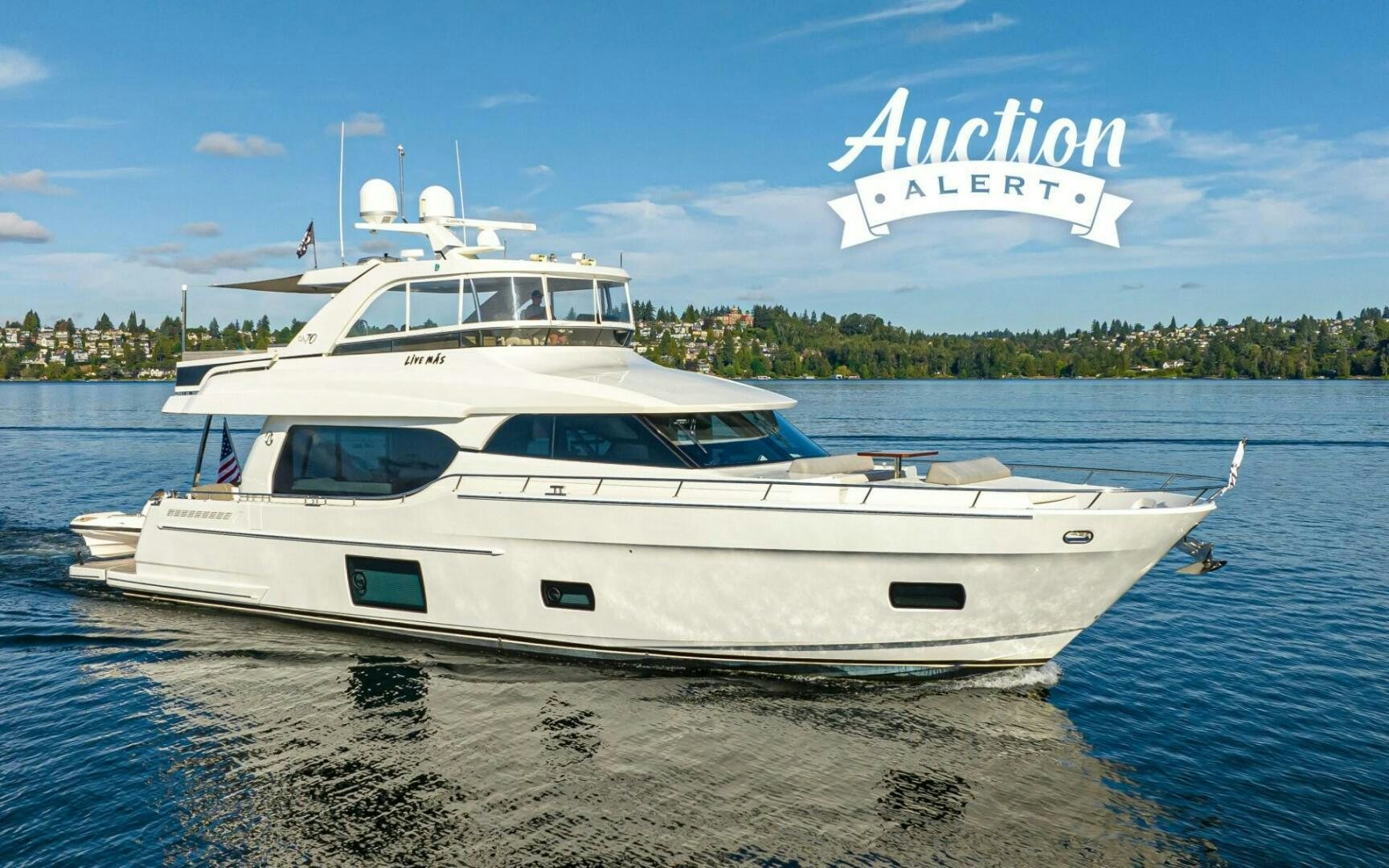 a white boat on a beach aboard LIV MAS Yacht for Sale