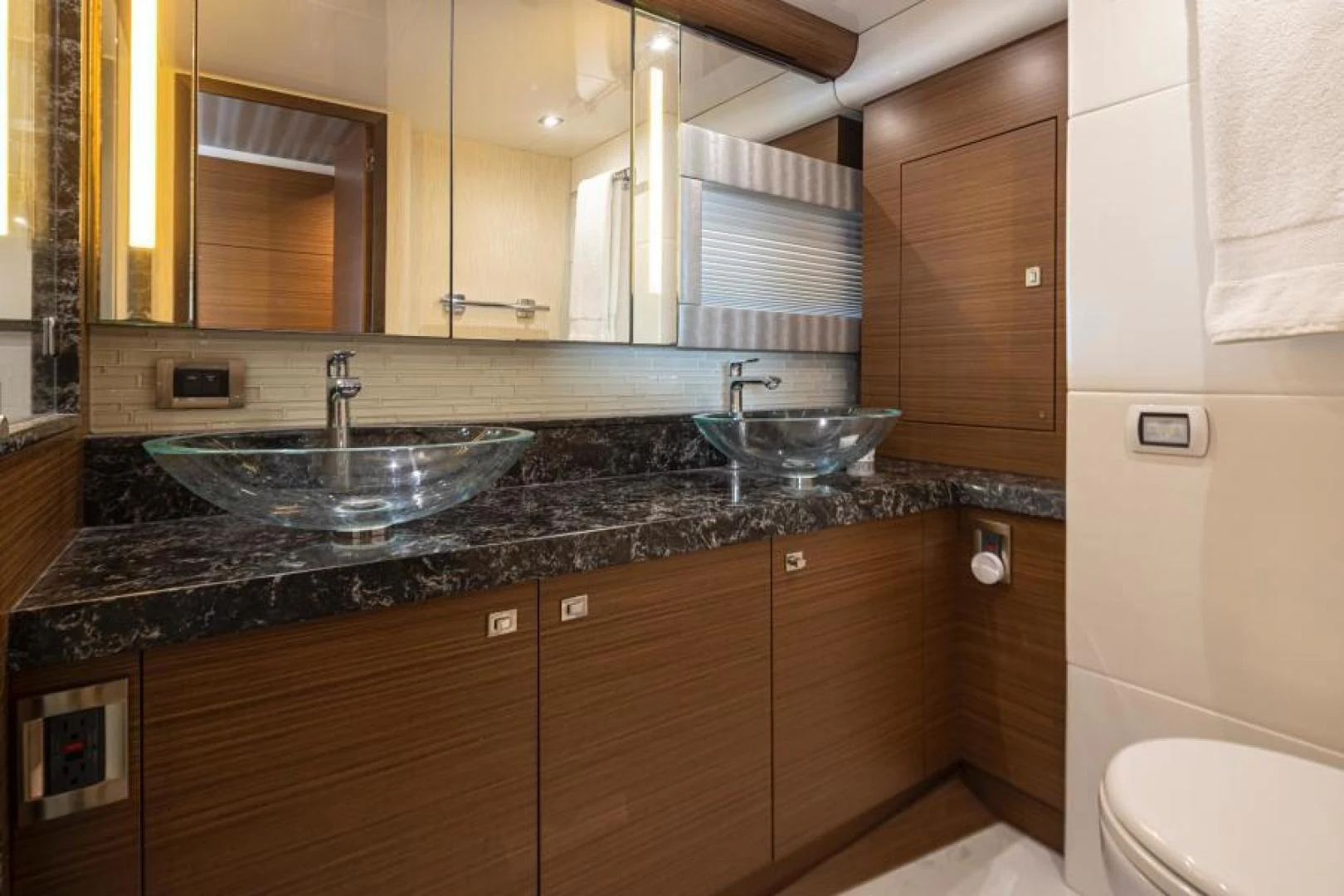 a bathroom with a sink and a mirror aboard LIV MAS Yacht for Sale