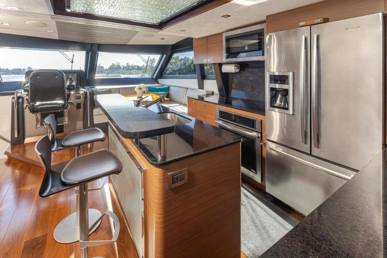a kitchen with a refrigerator and a table aboard LIV MAS Yacht for Sale