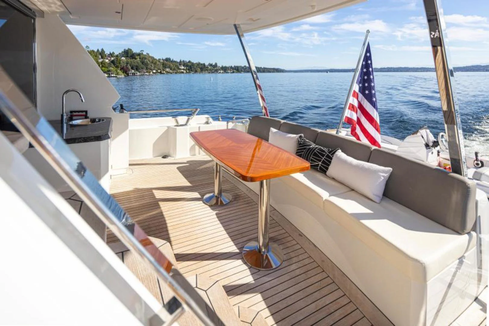 a boat with a flag on the deck aboard LIV MAS Yacht for Sale