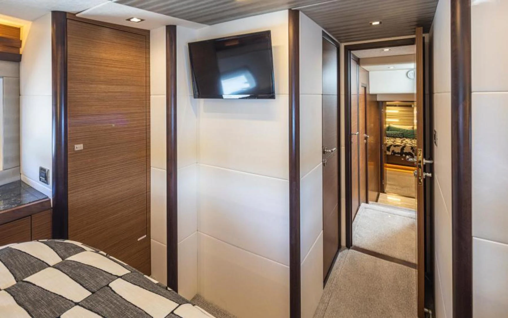 a room with a tv and a door aboard LIV MAS Yacht for Sale