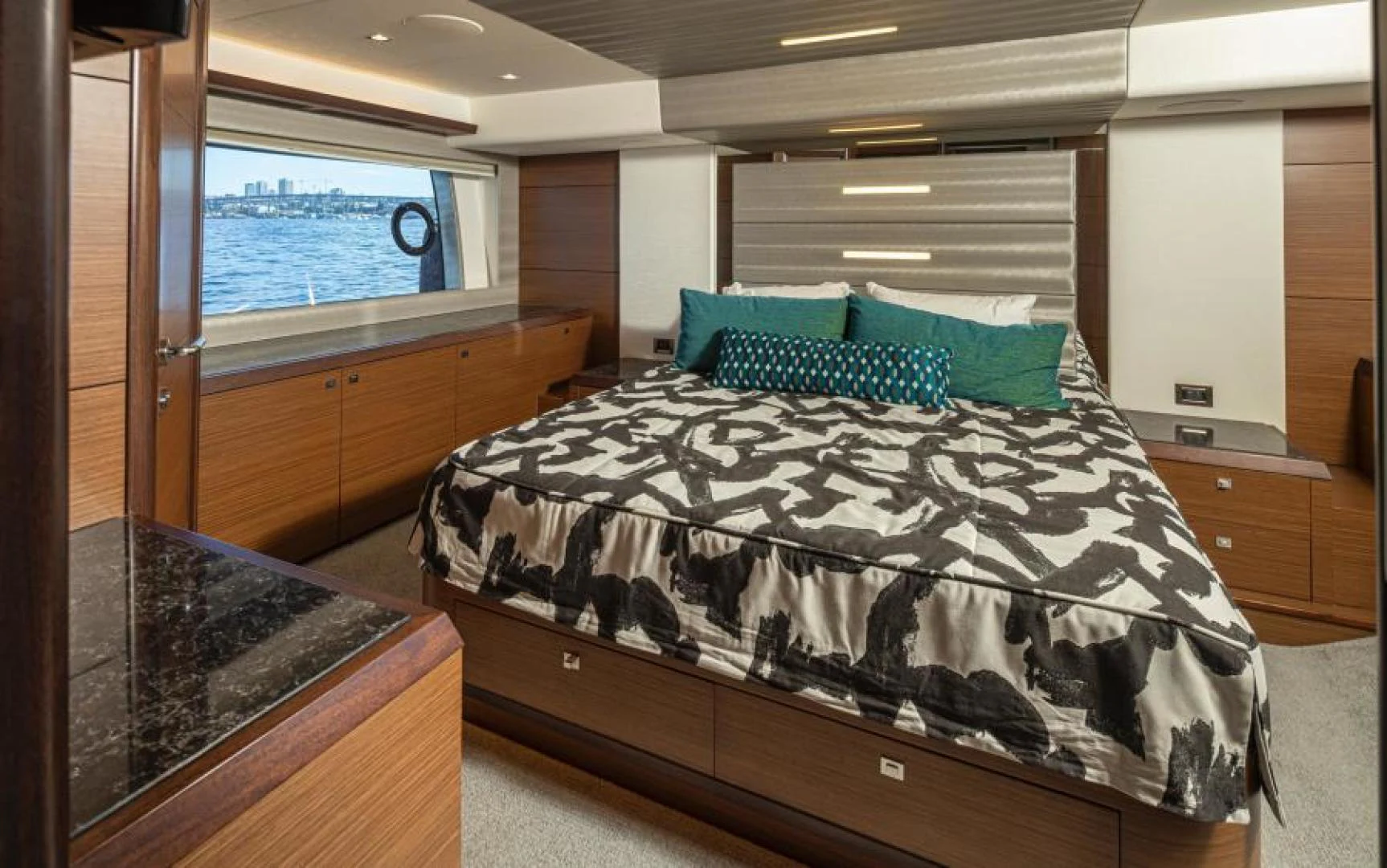 a bed with a black comforter aboard LIV MAS Yacht for Sale
