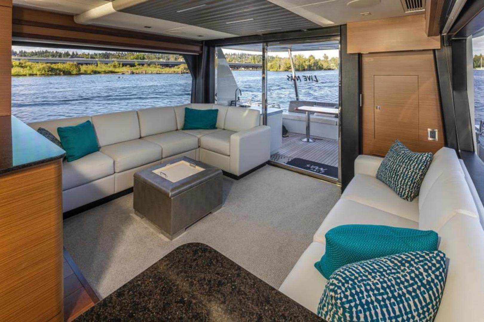 a living room with a couch and a table aboard LIV MAS Yacht for Sale