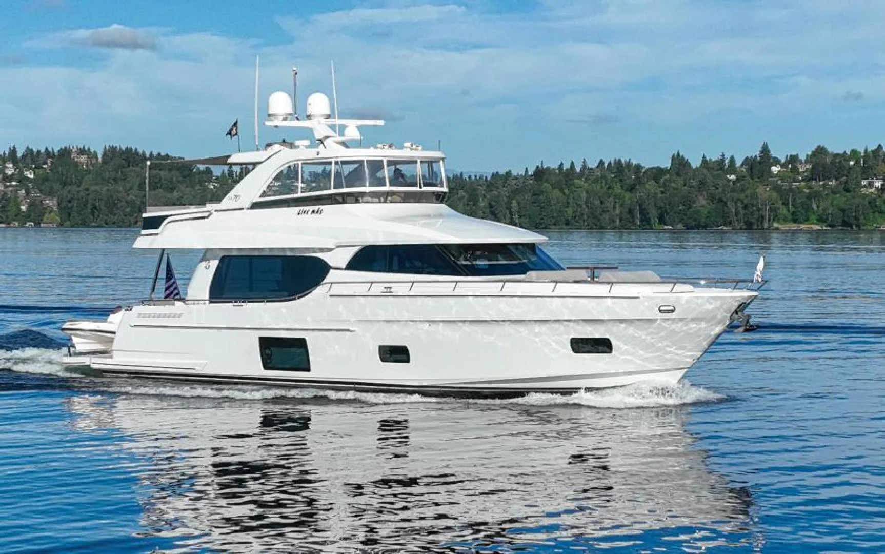 a white boat on the water aboard LIV MAS Yacht for Sale