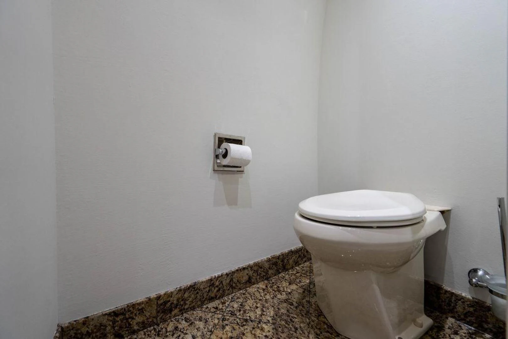 a toilet with rolls of toilet paper on the wall aboard THREE BLESSINGS Yacht for Sale