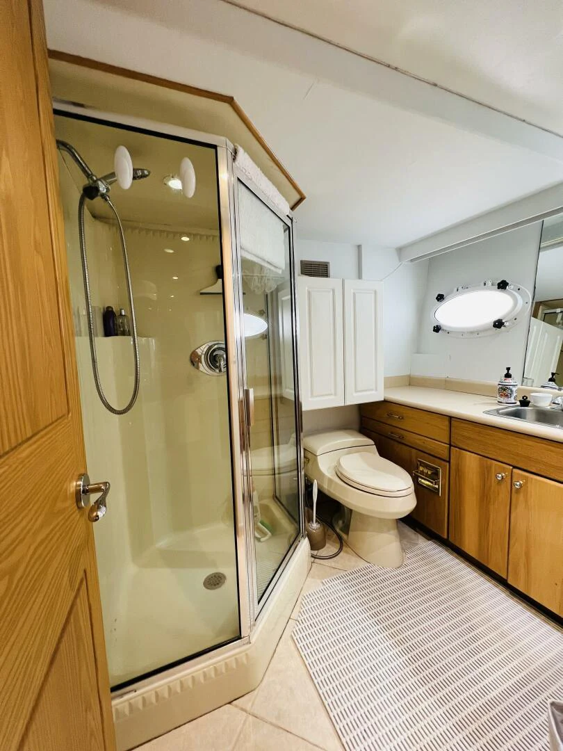 a bathroom with a glass shower door aboard THREE BLESSINGS Yacht for Sale