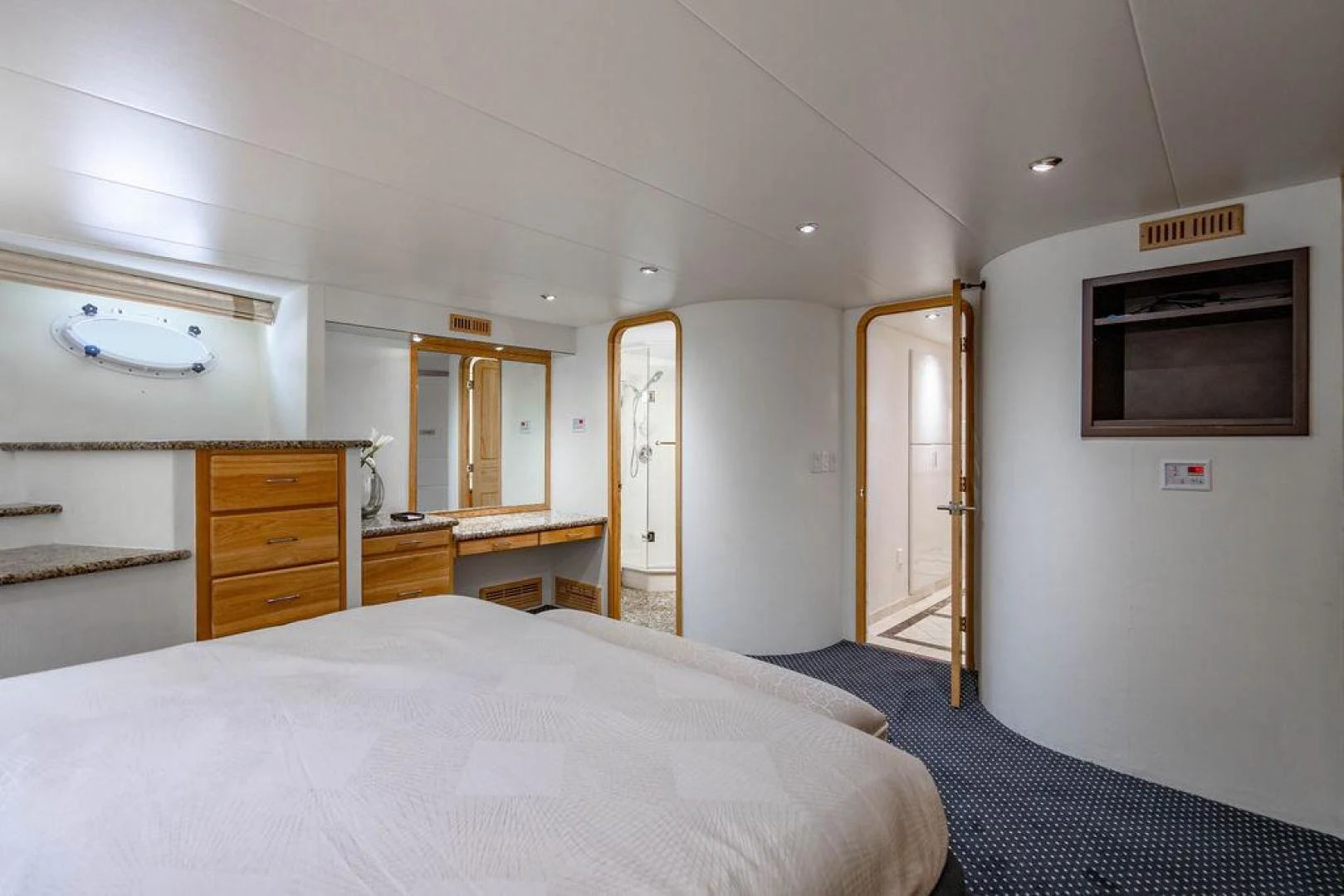 a bedroom with a bed and a television aboard THREE BLESSINGS Yacht for Sale